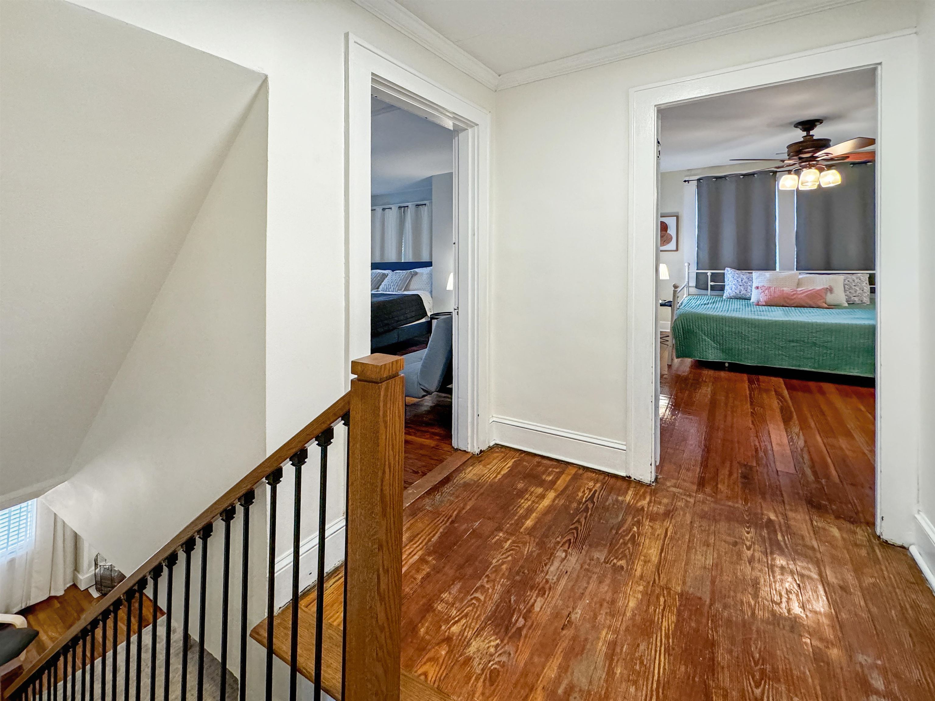 Hall featuring hardwood / wood-style floors and crown molding