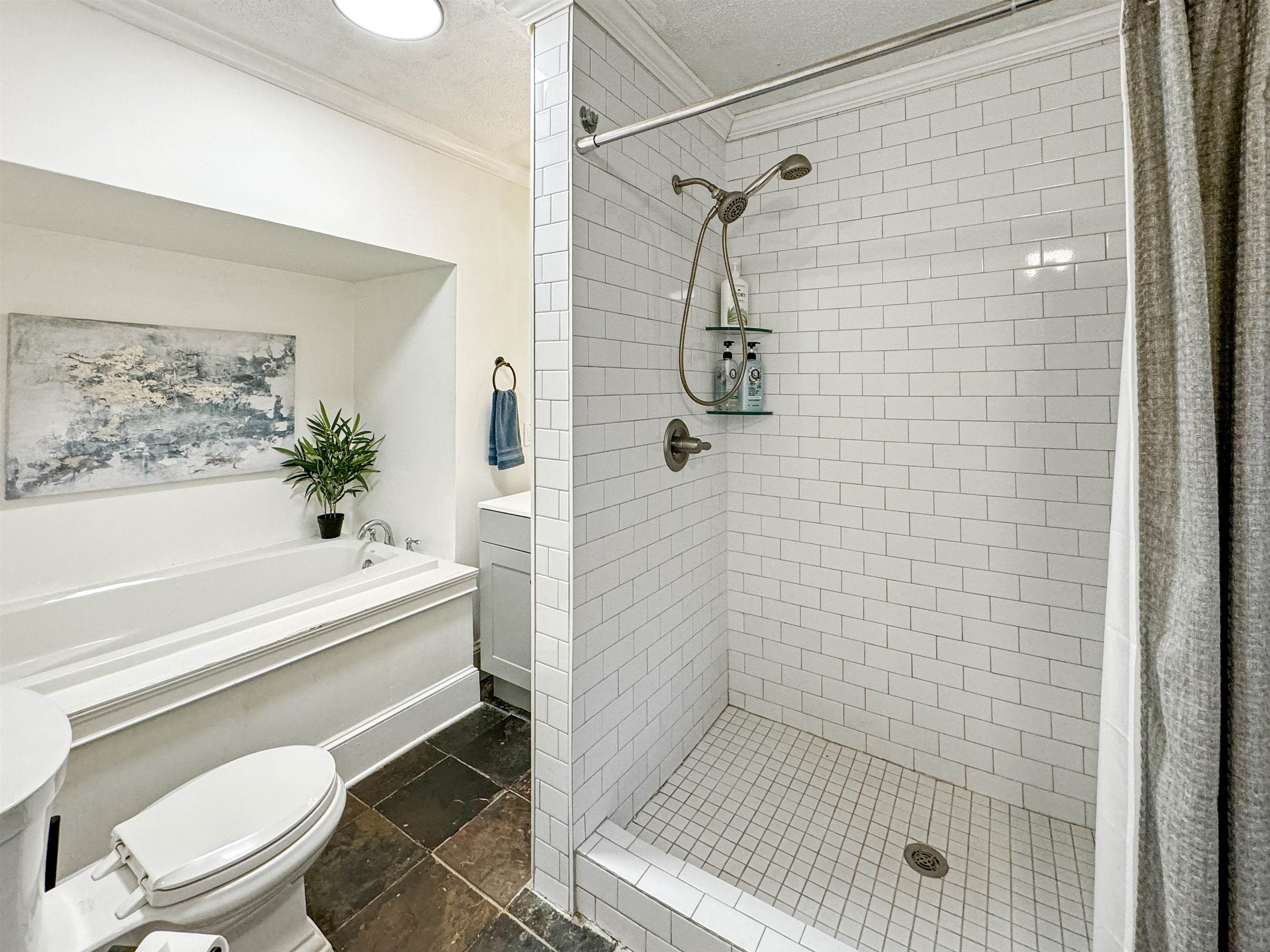 Full bathroom with a textured ceiling, independent shower and bath, crown molding, vanity, and toilet