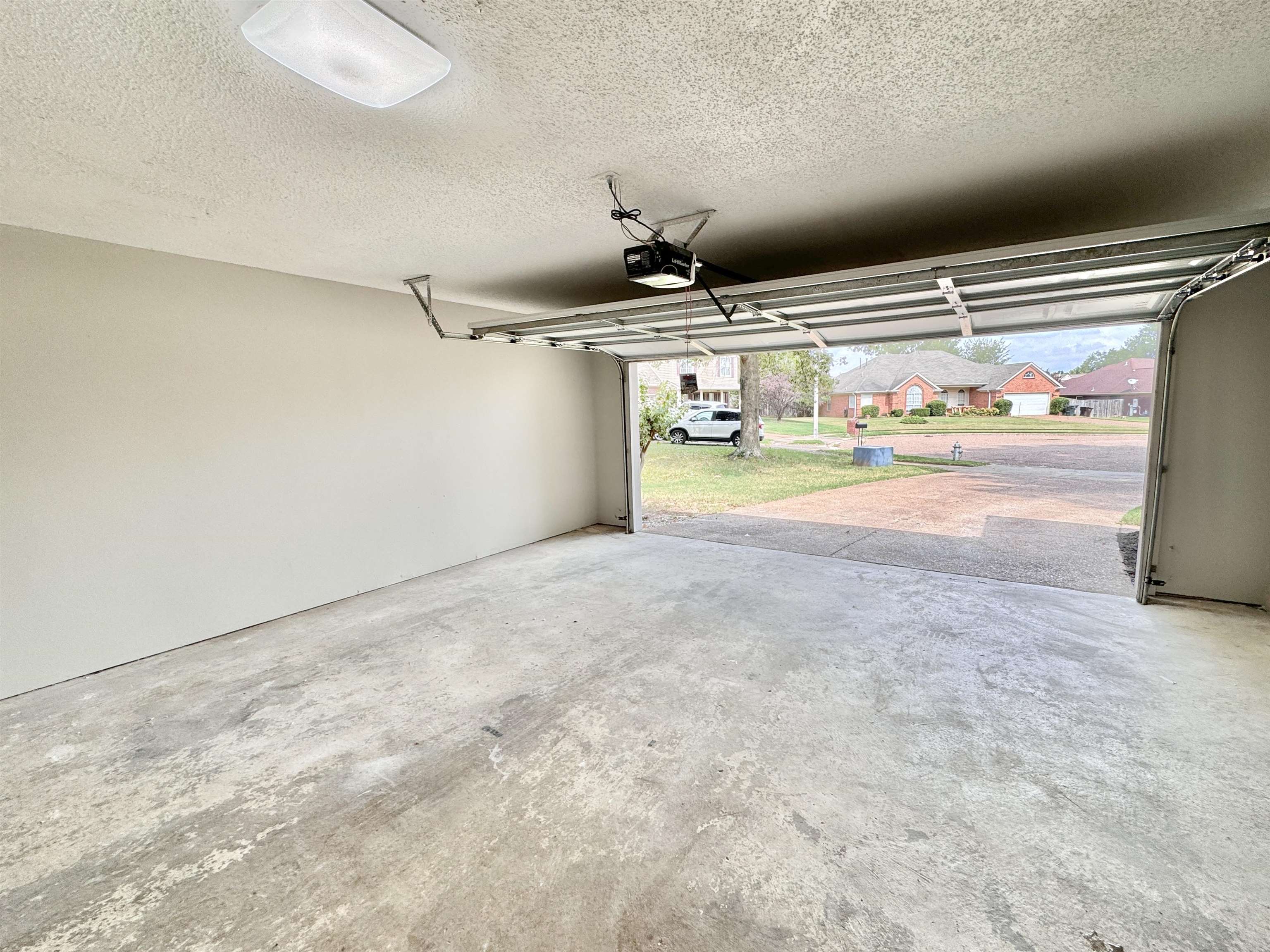 Garage featuring a garage door opener