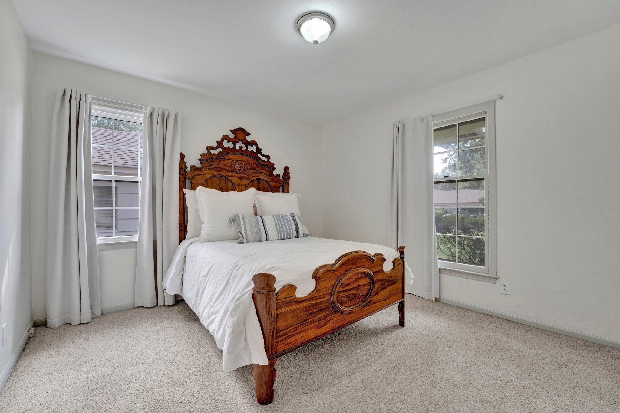 Bedroom with light carpet