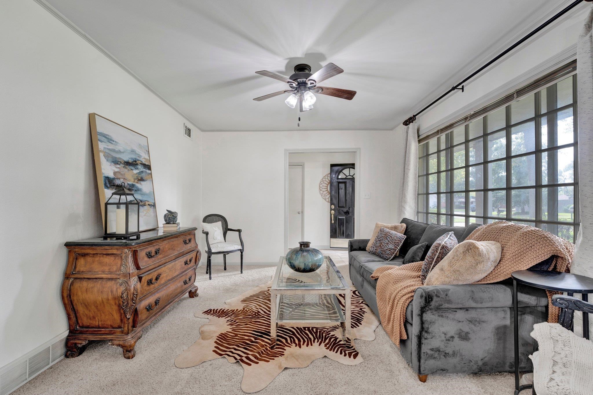 Living room with light carpet and ceiling fan