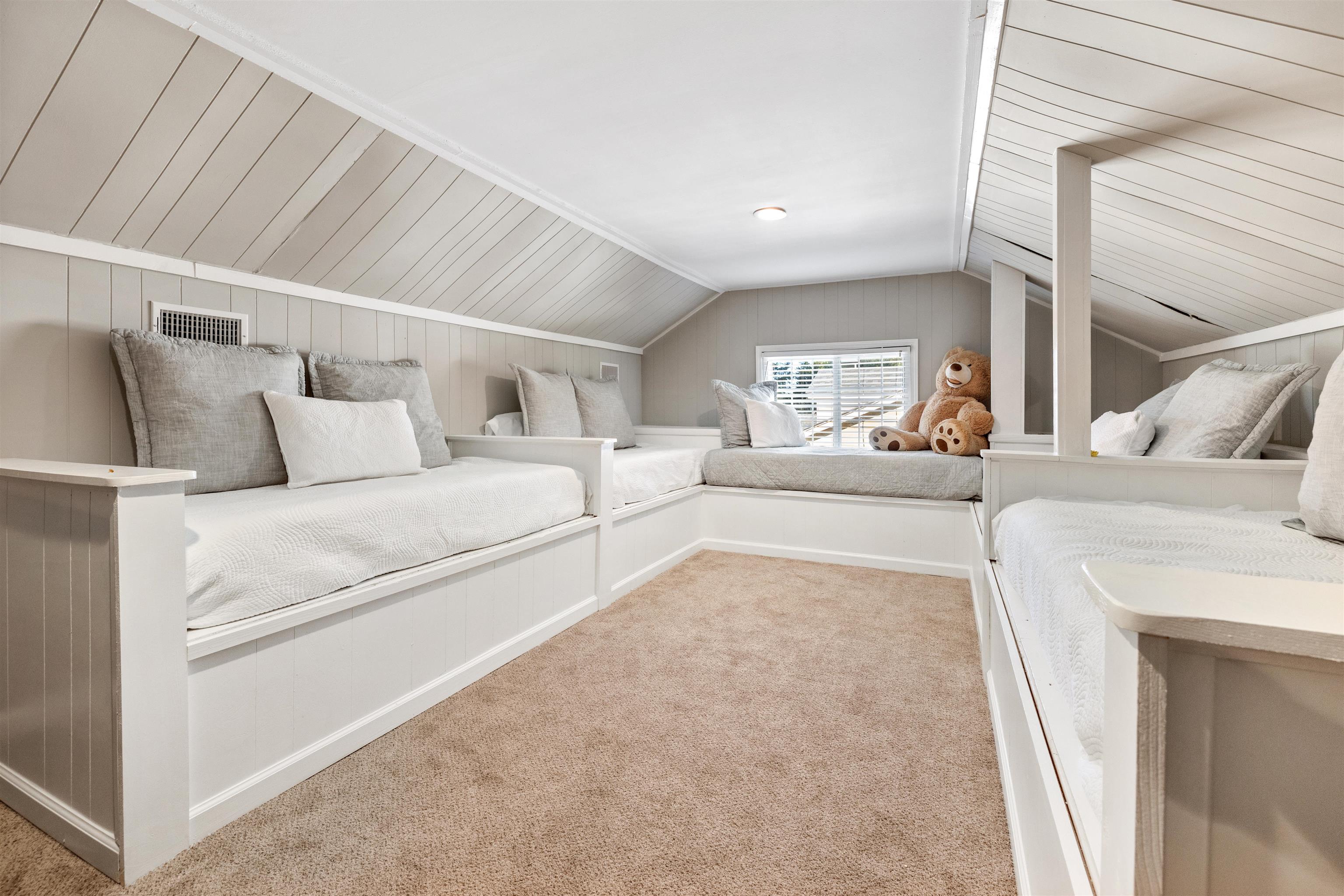 Interior space featuring carpet floors, vaulted ceiling, and wooden ceiling