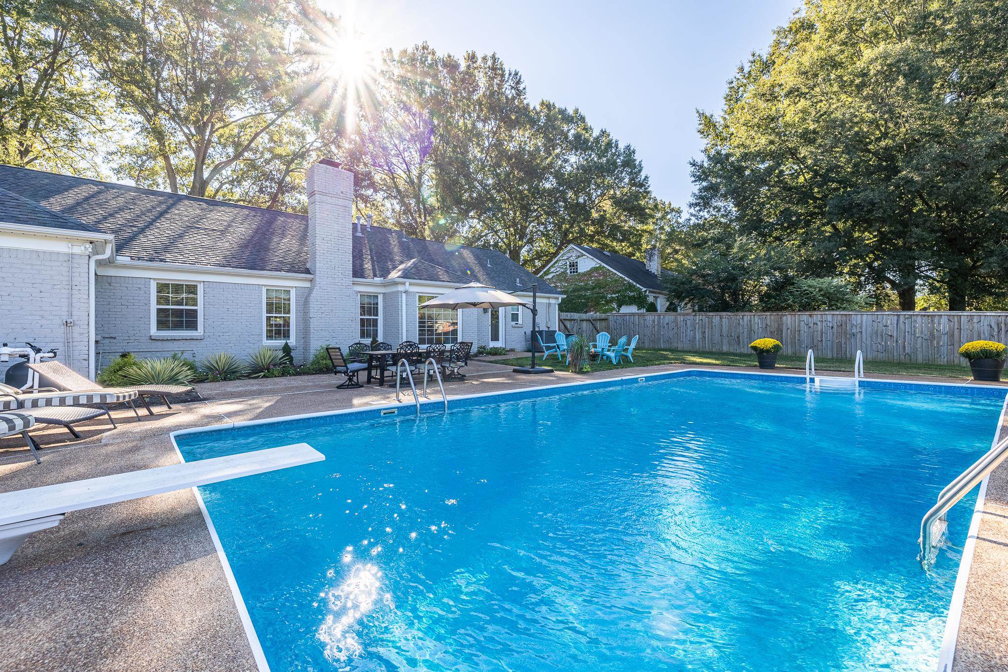 View of pool featuring a diving board and a patio