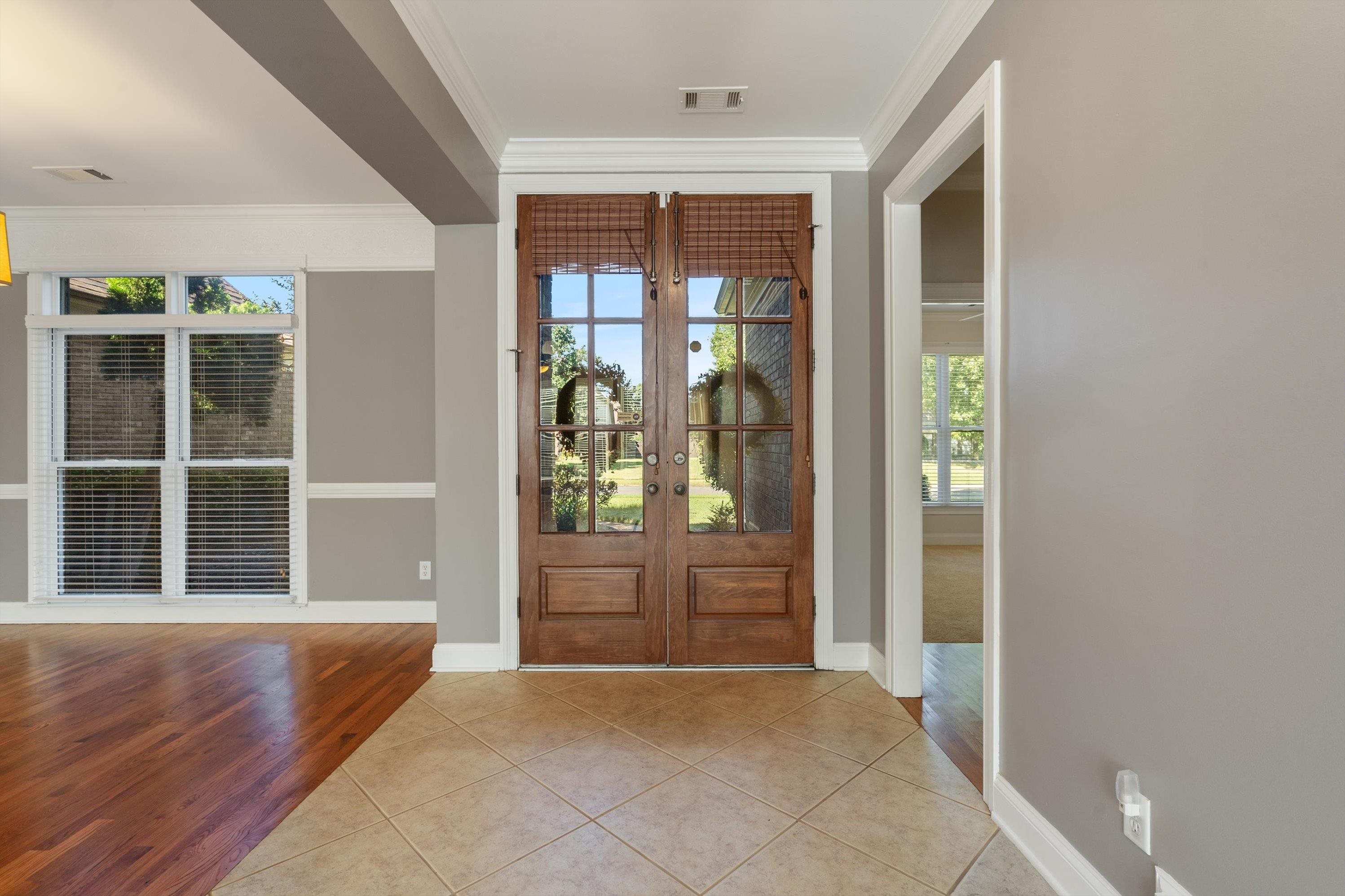 Entrance foyer with tile & gleaming hardwood floors