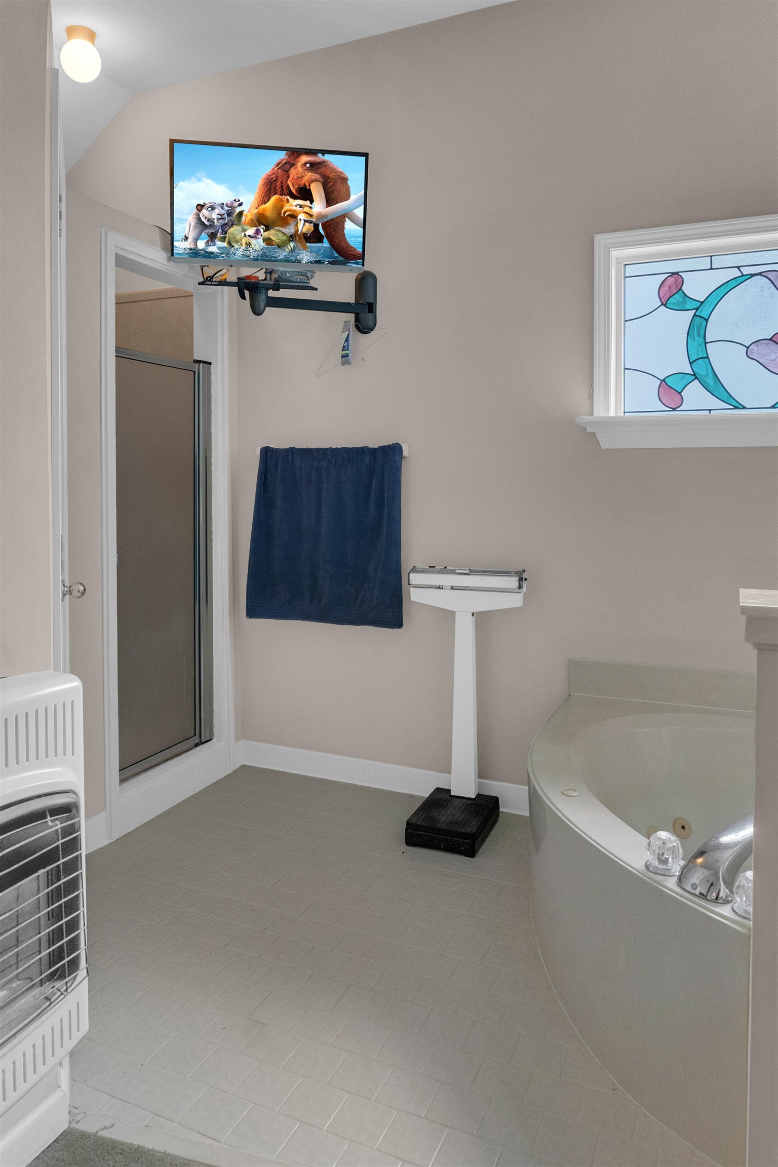 Bathroom with independent shower and bath, vaulted ceiling, and tile patterned floors