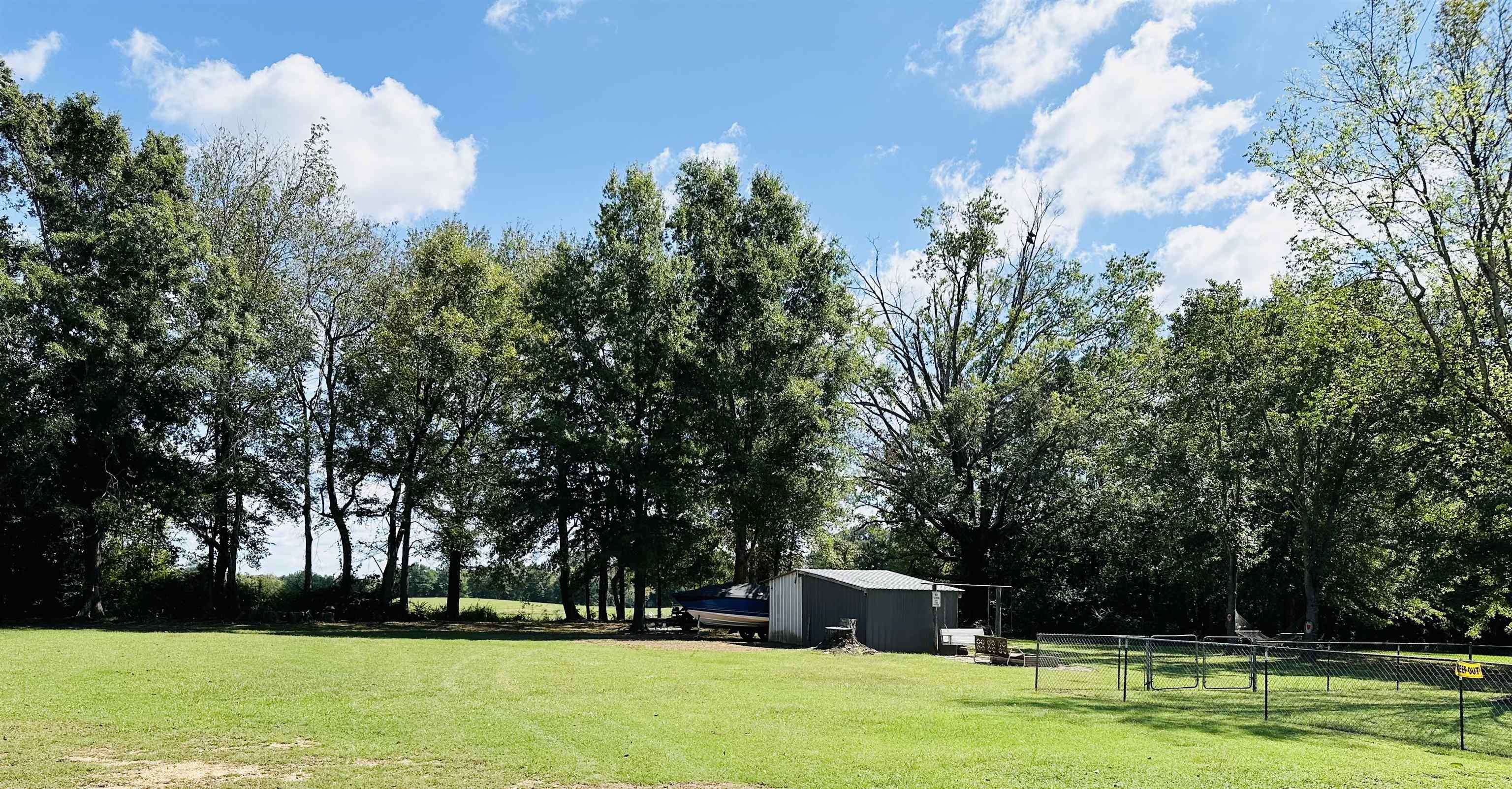 View of yard with a rural view and a shed