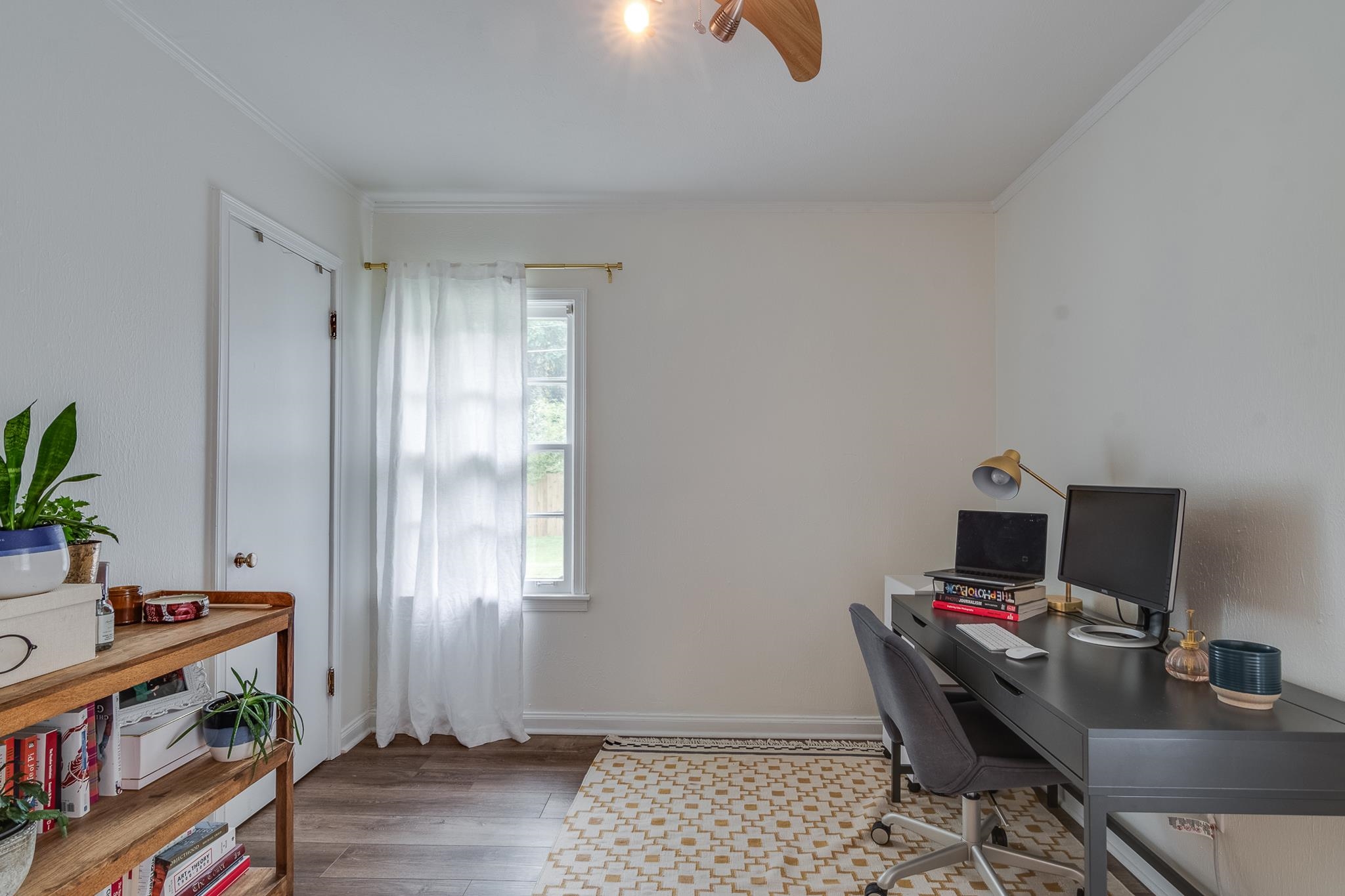 Office area with crown molding and dark hardwood / wood-style flooring