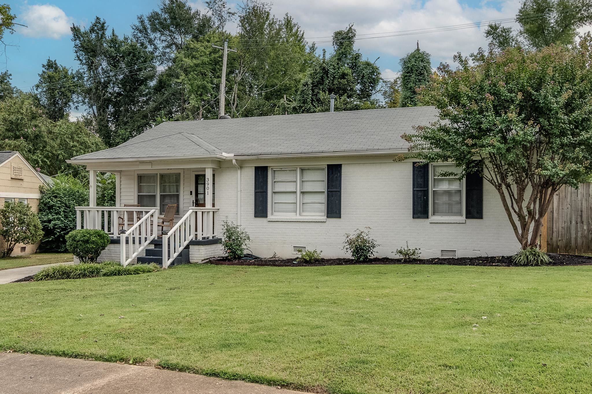 Single story home featuring a front yard and covered porch