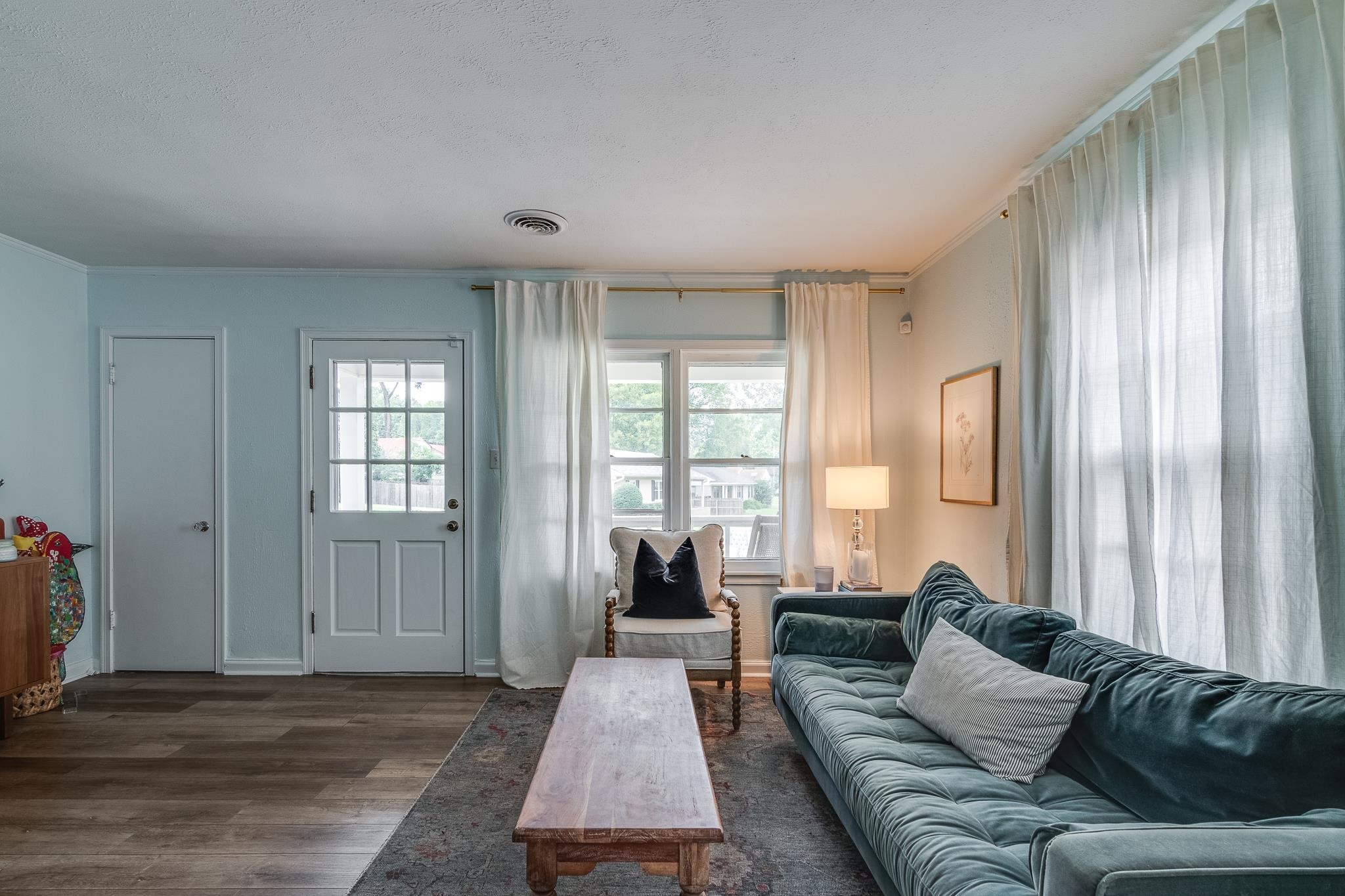 Living room featuring dark hardwood / wood-style floors and crown molding