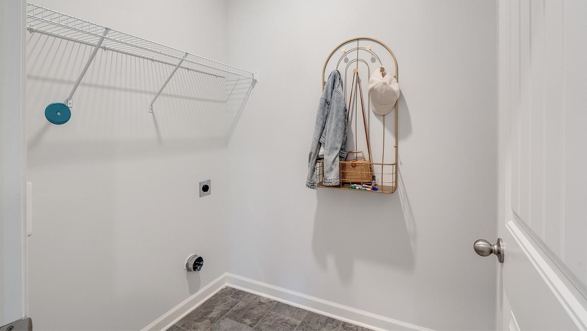 Laundry room featuring hookup for an electric dryer and dark wood-type flooring