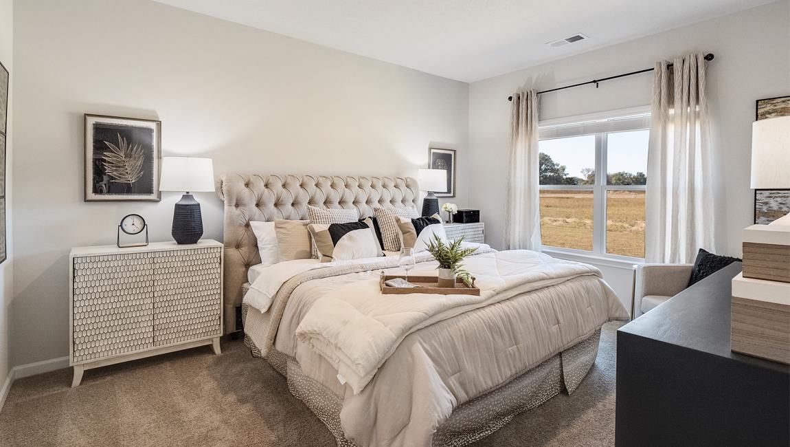 Bedroom with dark colored carpet