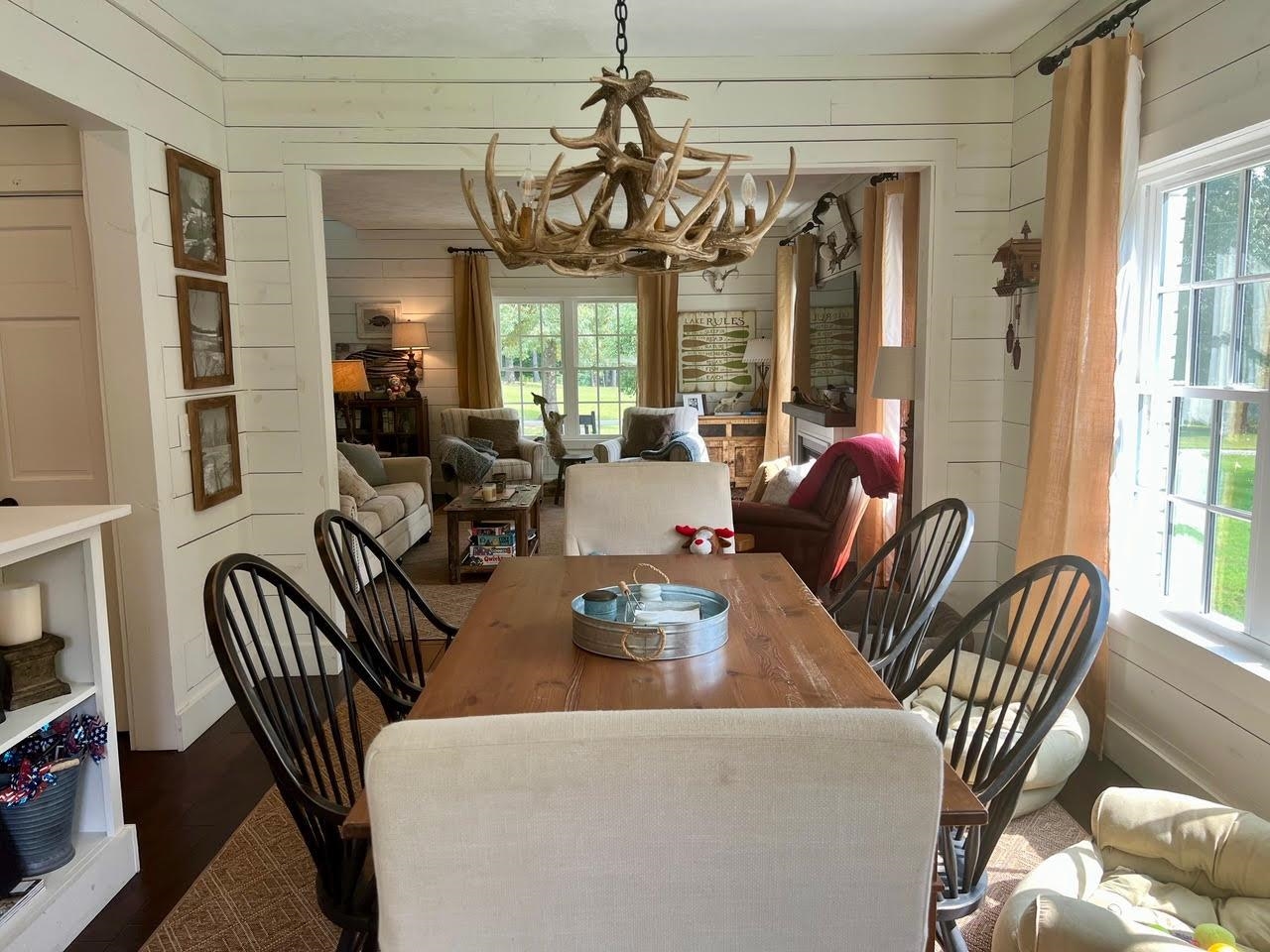 Dining area with wooden walls, dark hardwood / wood-style floors, and plenty of natural light