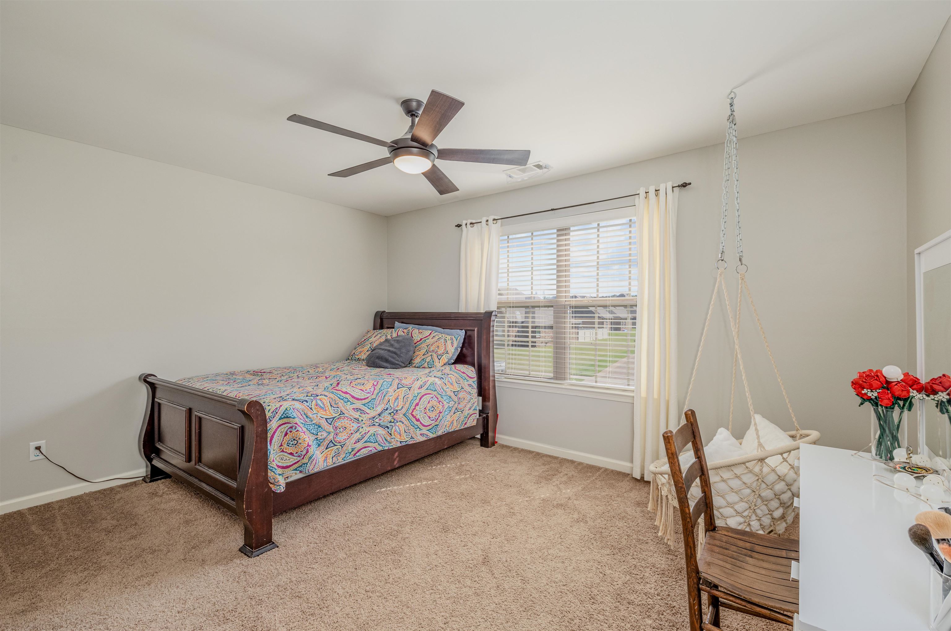 Bedroom 3 upstairs with light carpet and ceiling fan