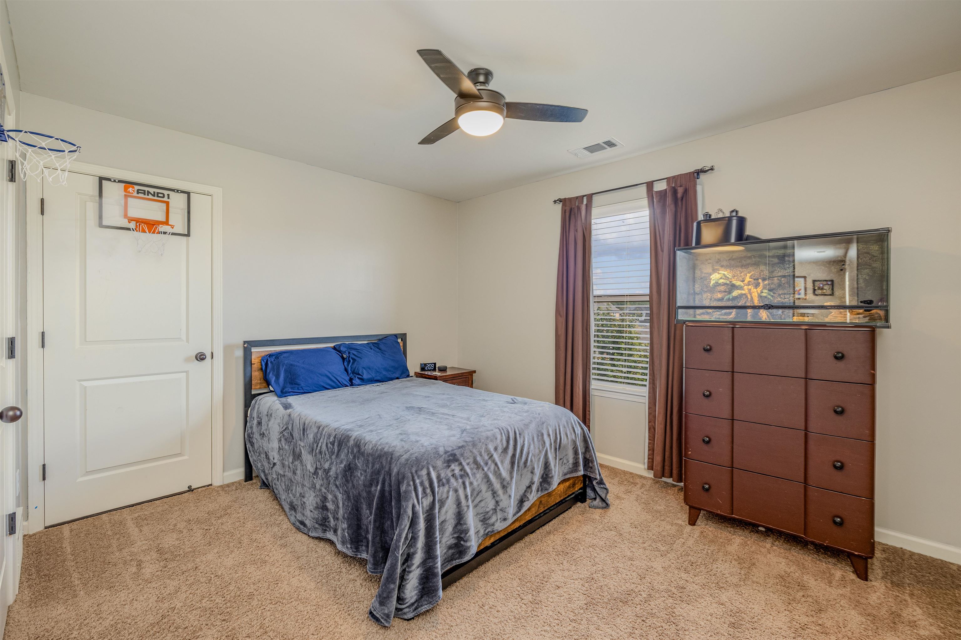 Bedroom featuring light carpet and ceiling fan