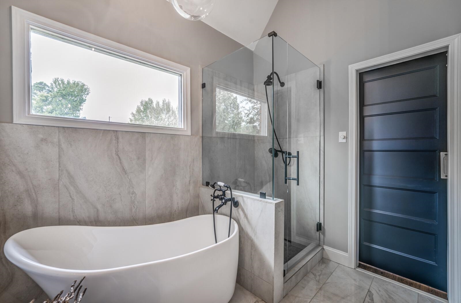 Bathroom with shower with separate bathtub and vaulted ceiling