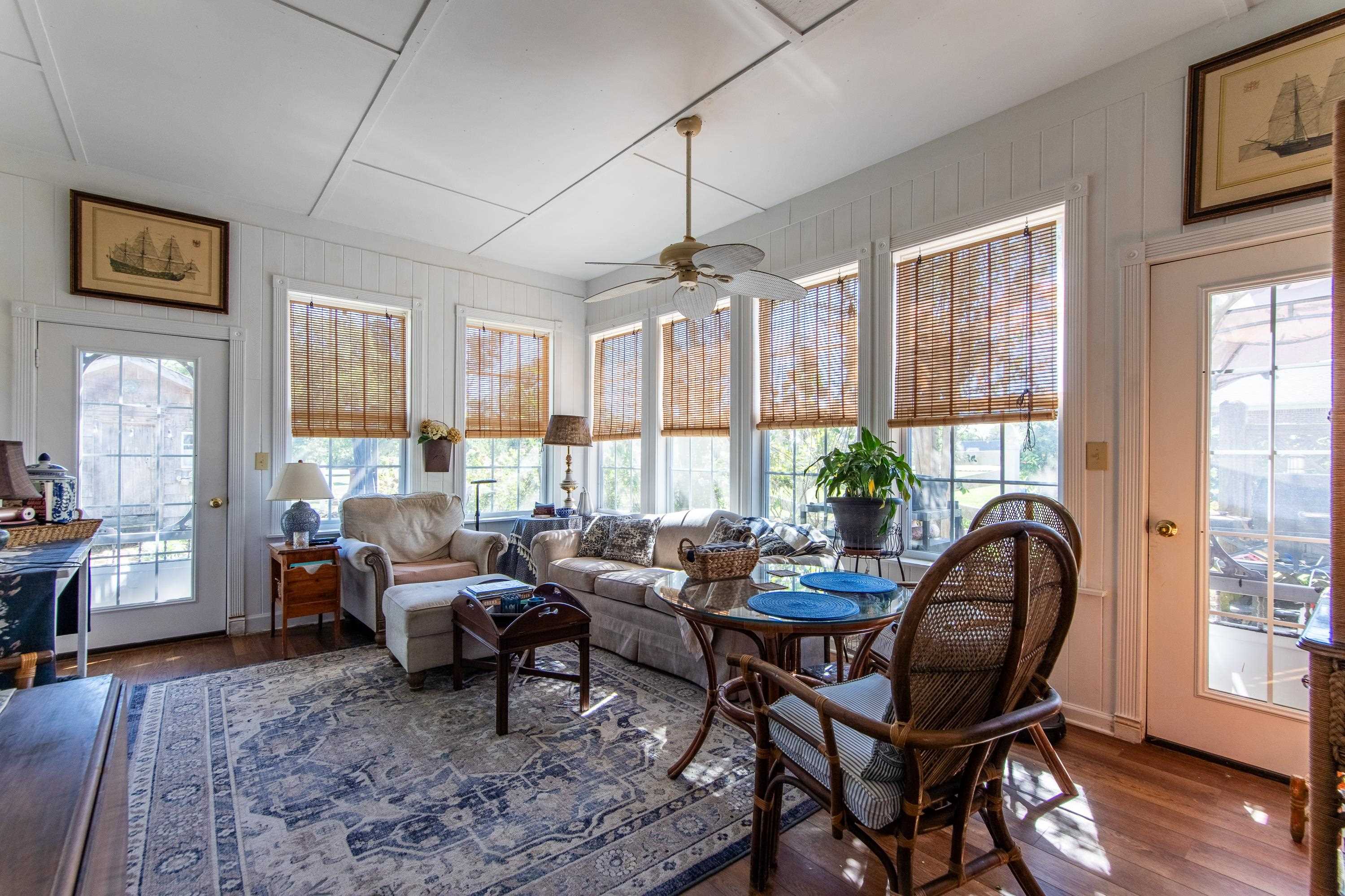 Sunroom / solarium featuring ceiling fan