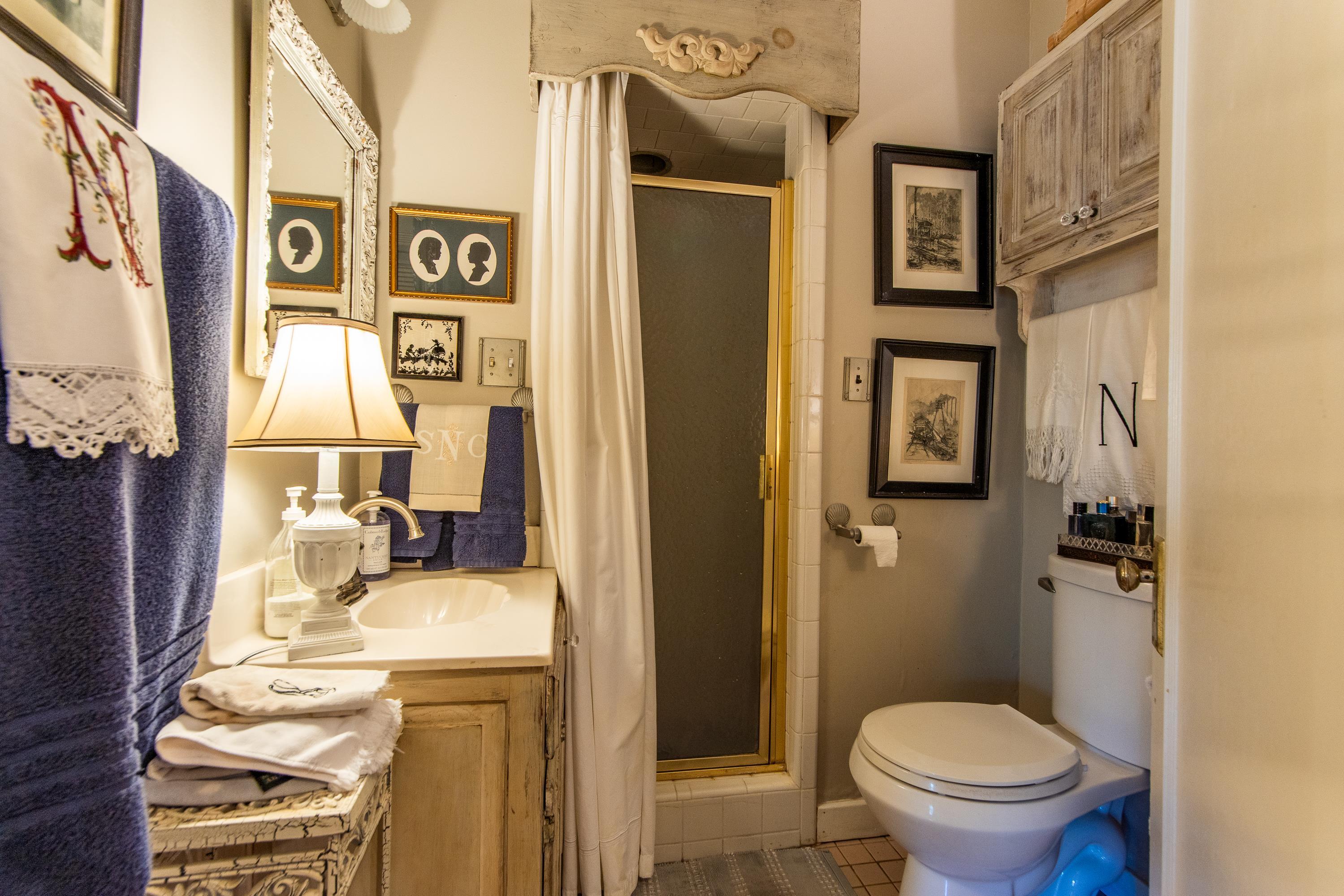 Bathroom with walk in shower, vanity, toilet, and tile patterned floors