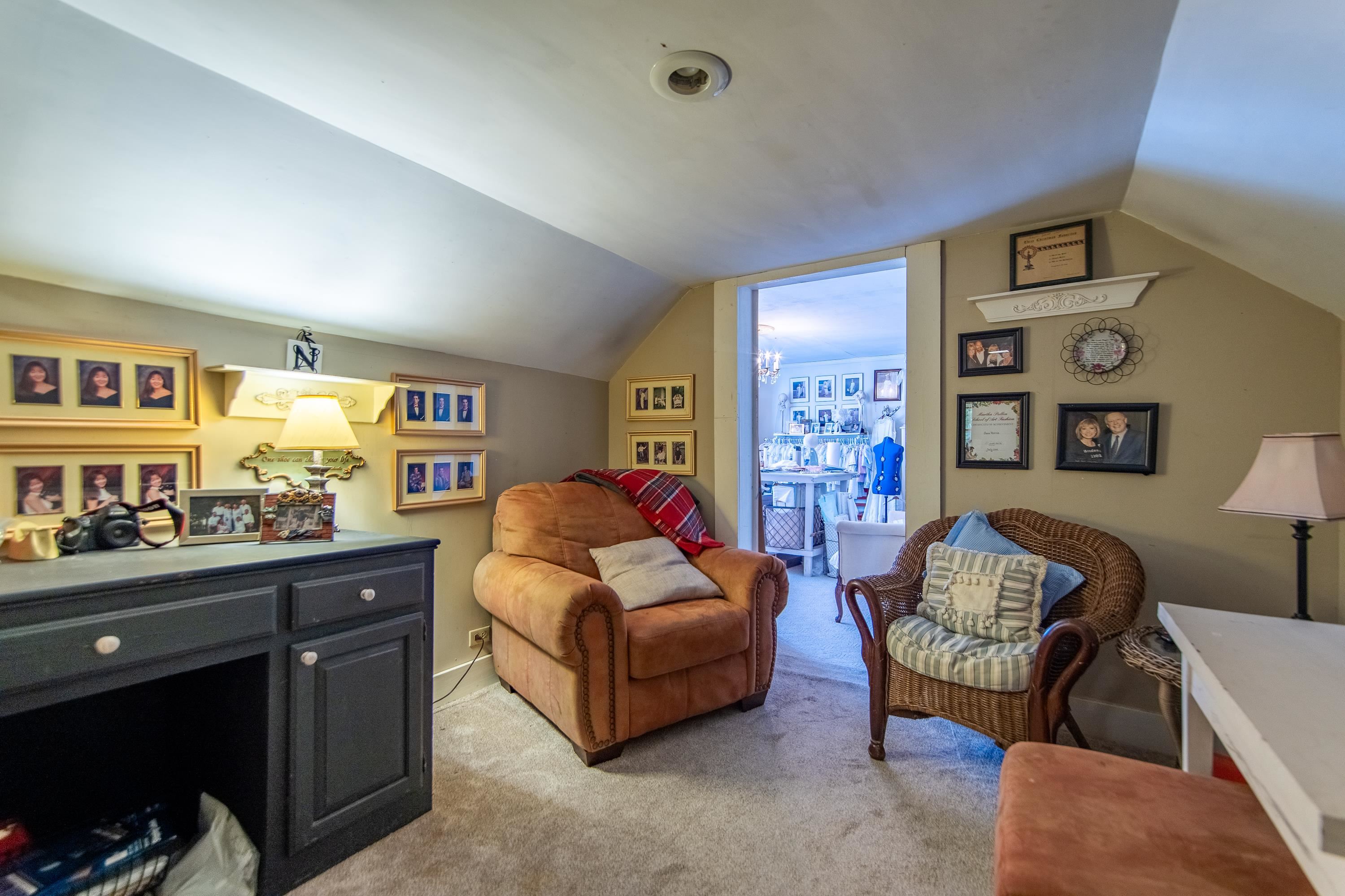 Carpeted living room with vaulted ceiling