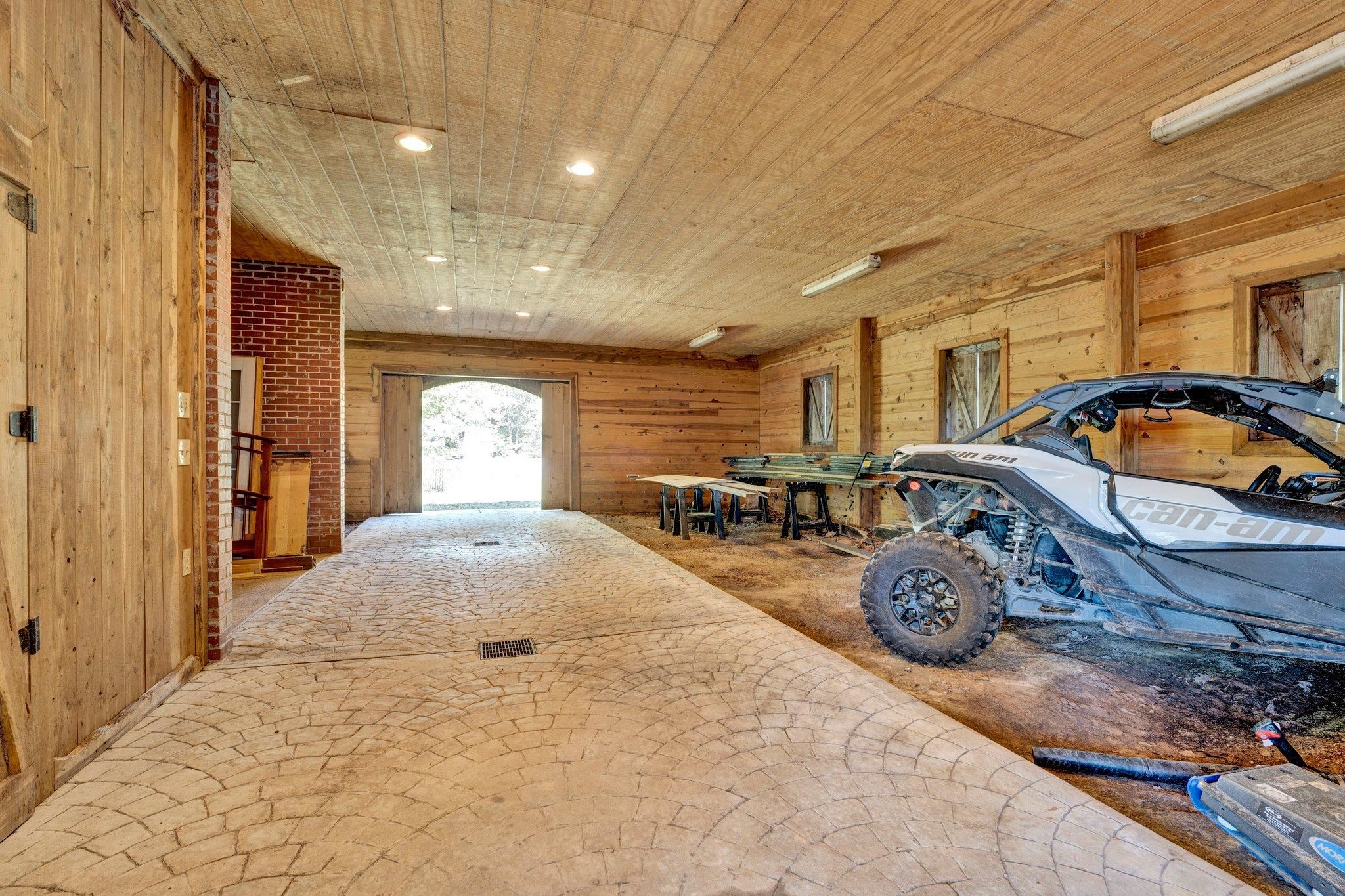 Garage featuring wood walls and wooden ceiling