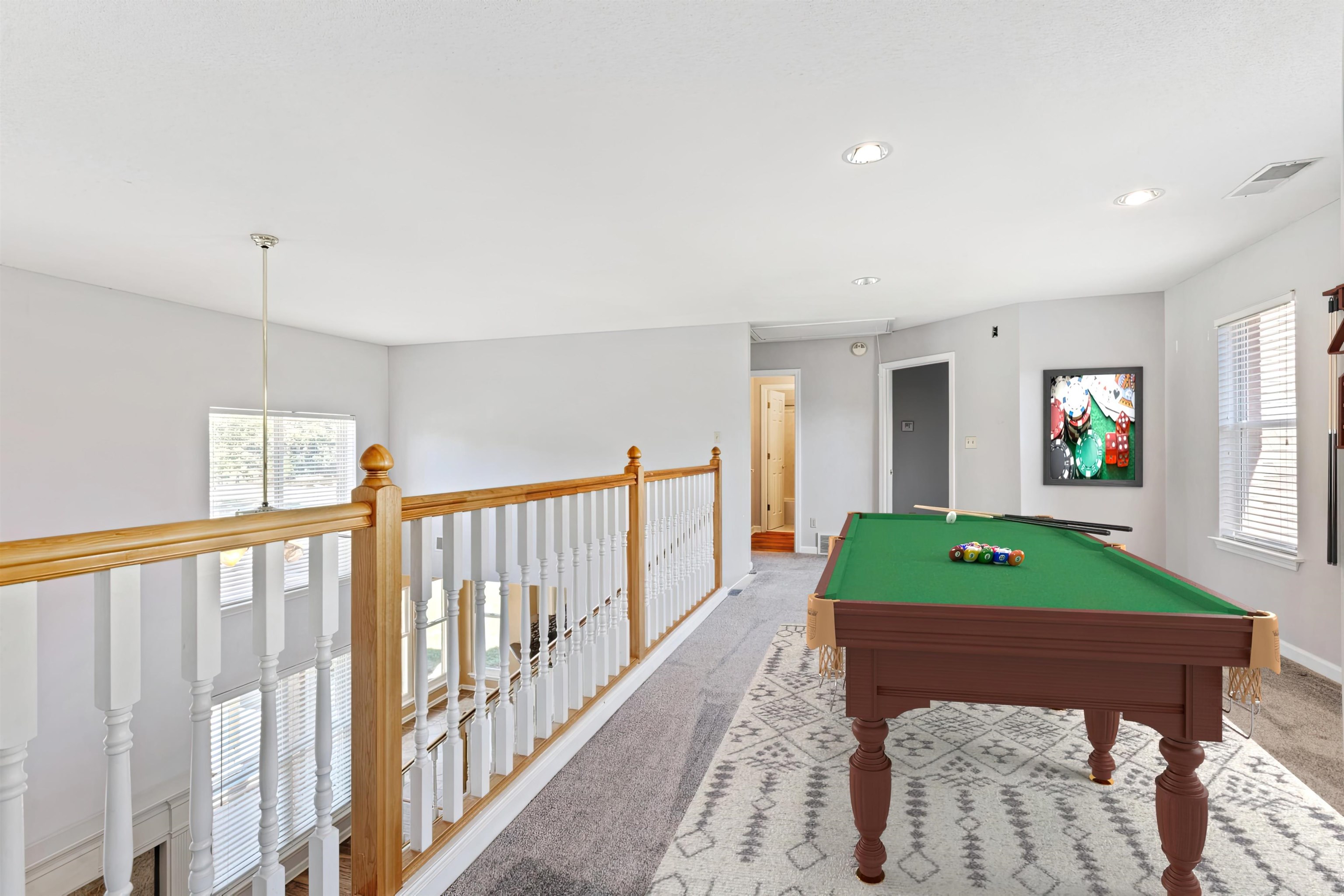 Playroom featuring light colored carpet, billiards, and plenty of natural light