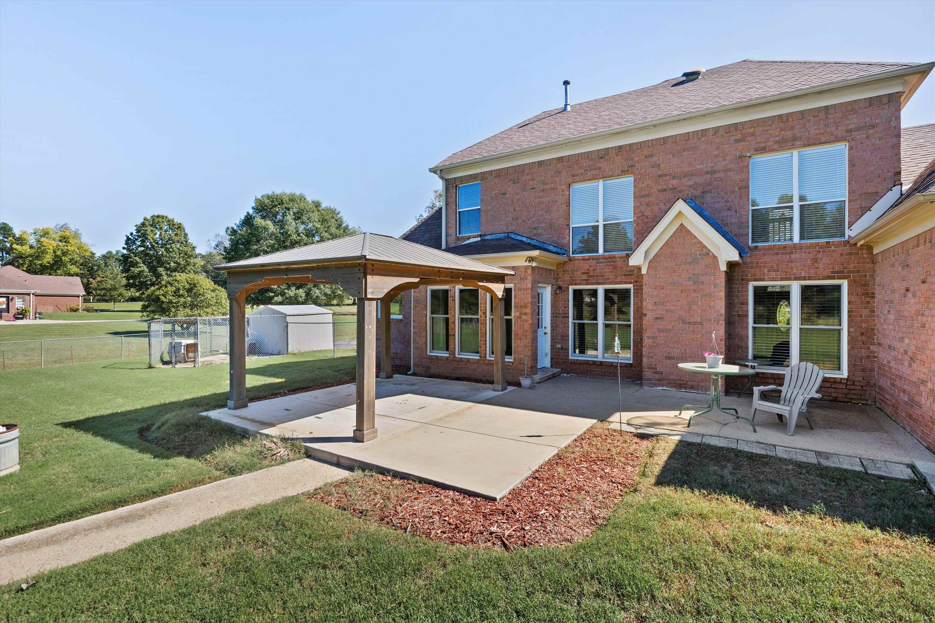 Back of house with a gazebo, a yard, and a patio area