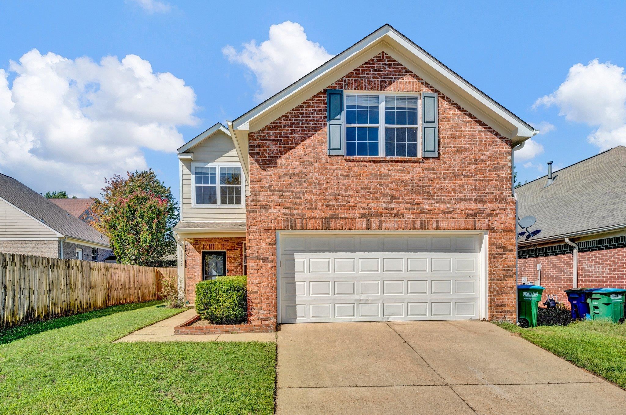 Front of property featuring a garage and a front yard