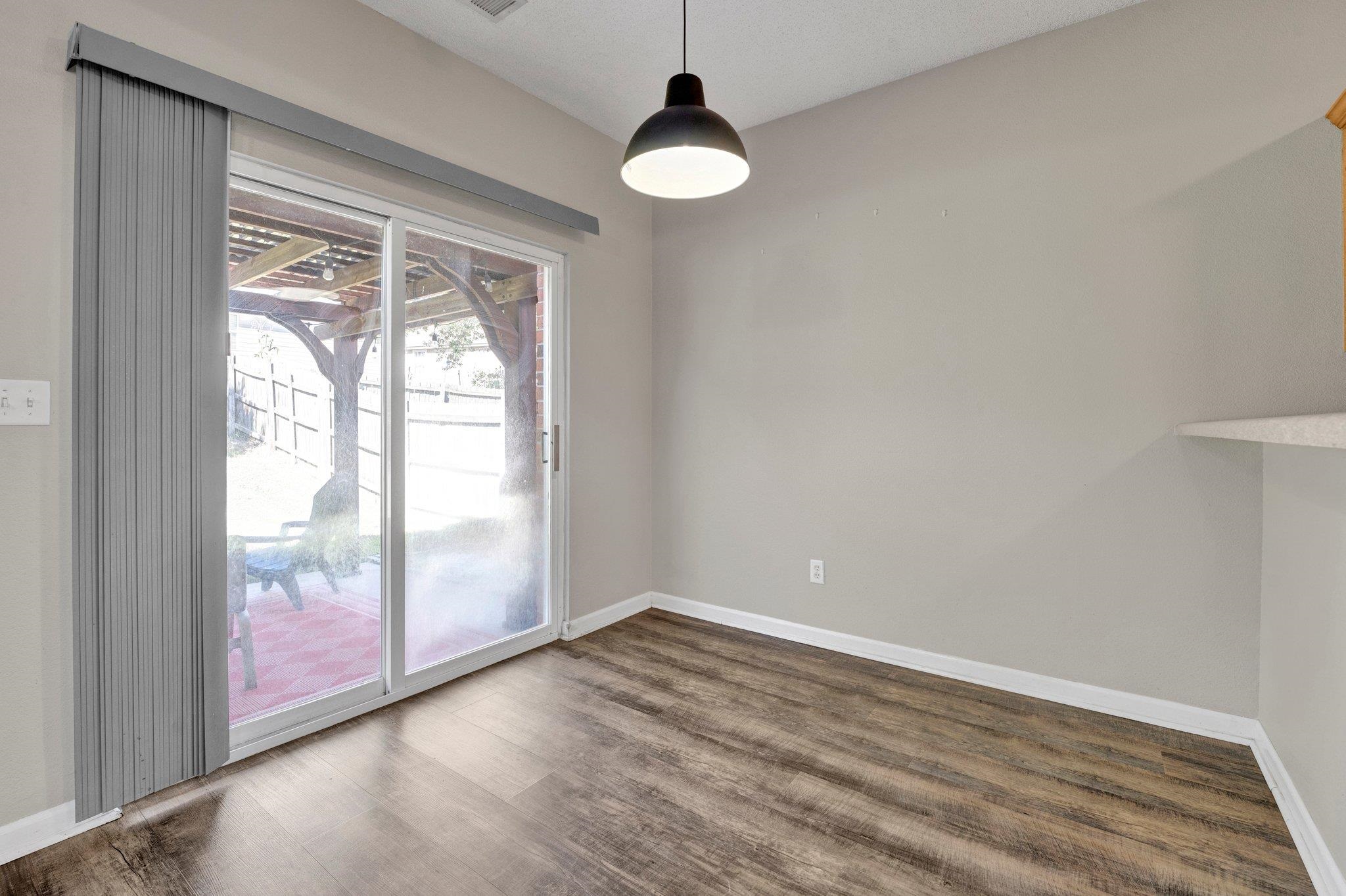 Unfurnished dining area with dark hardwood / wood-style flooring