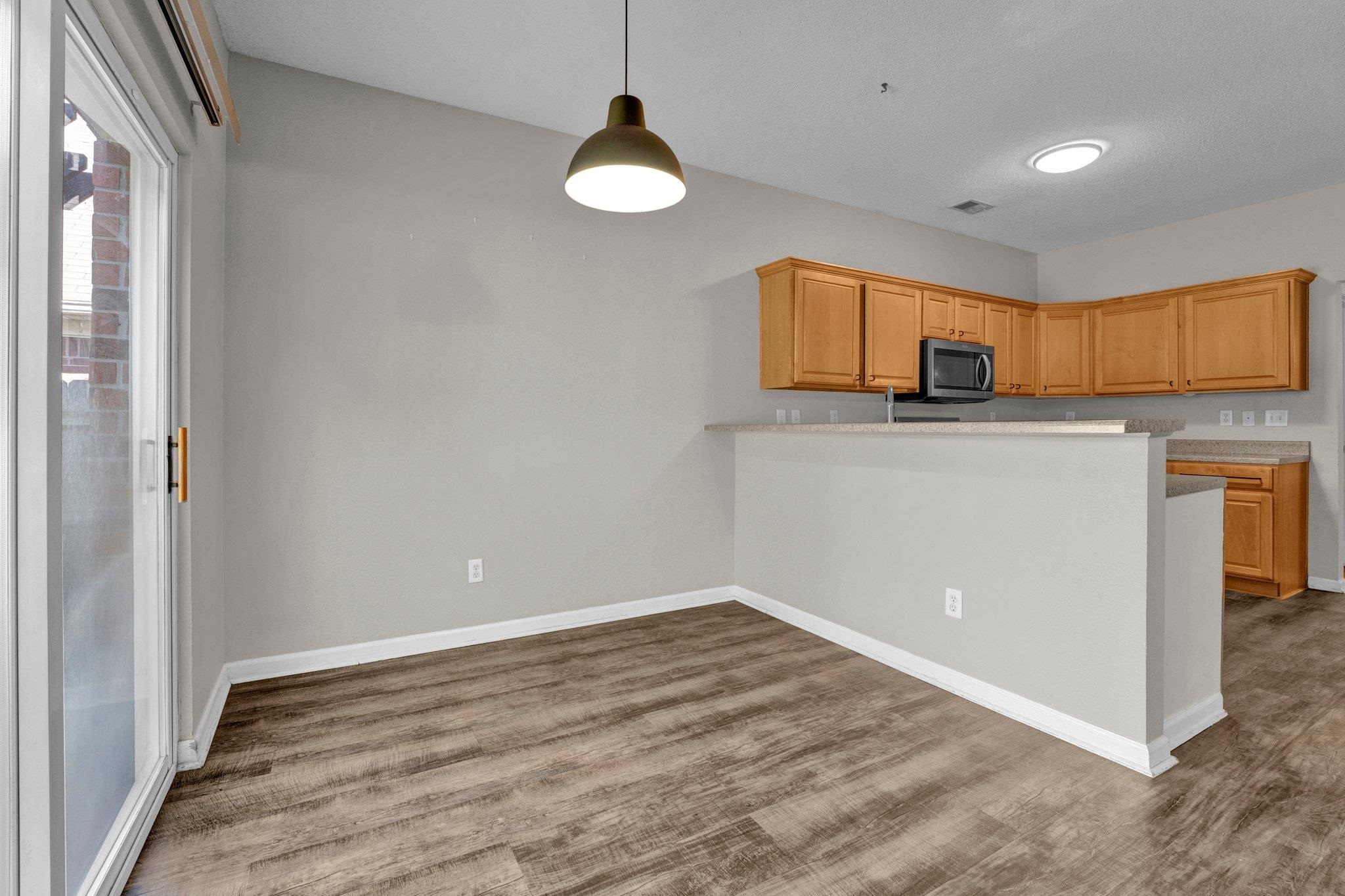 Kitchen with wood-type flooring and kitchen peninsula