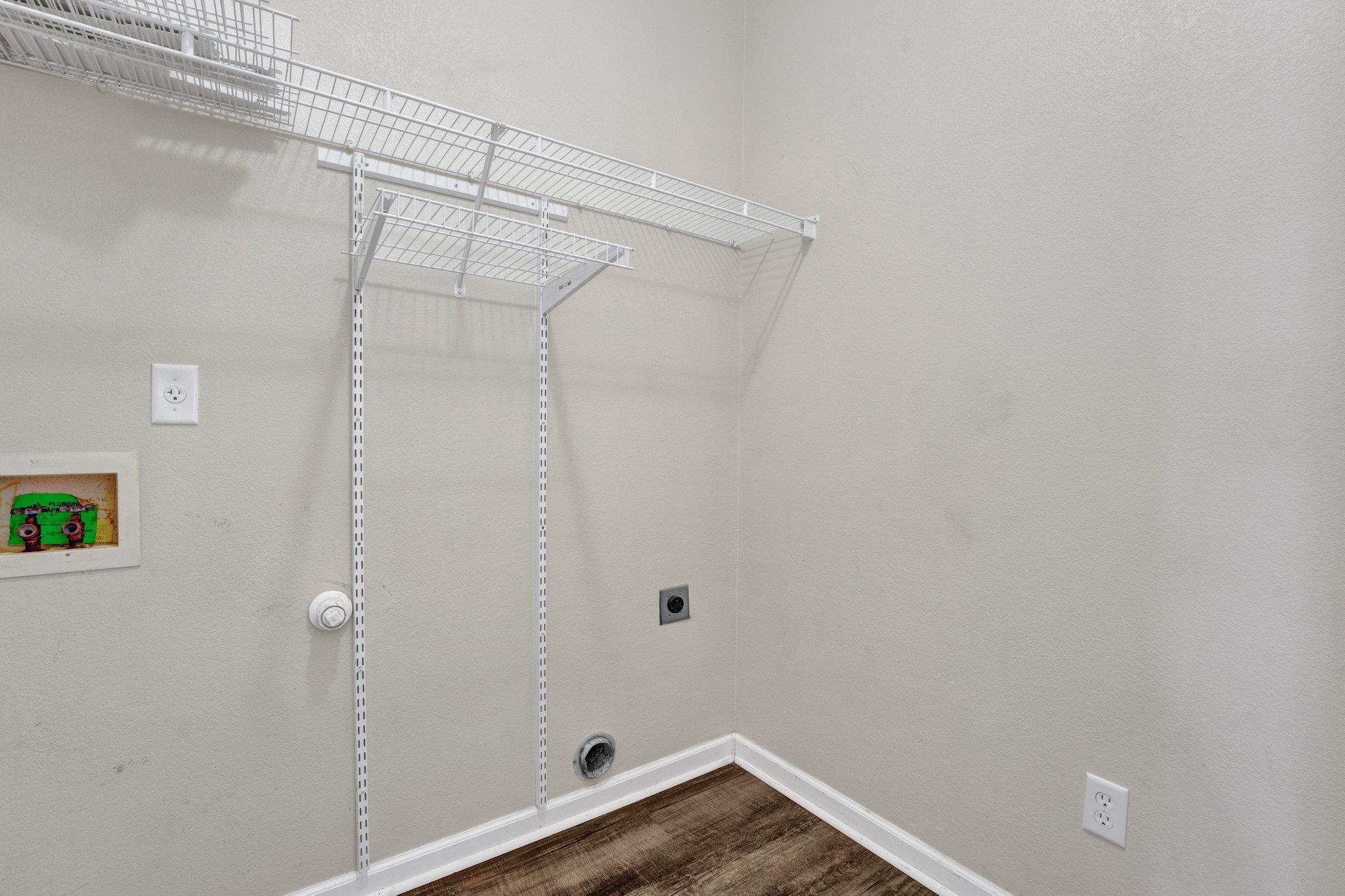 Clothes washing area featuring hookup for a washing machine, hardwood / wood-style floors, and electric dryer hookup