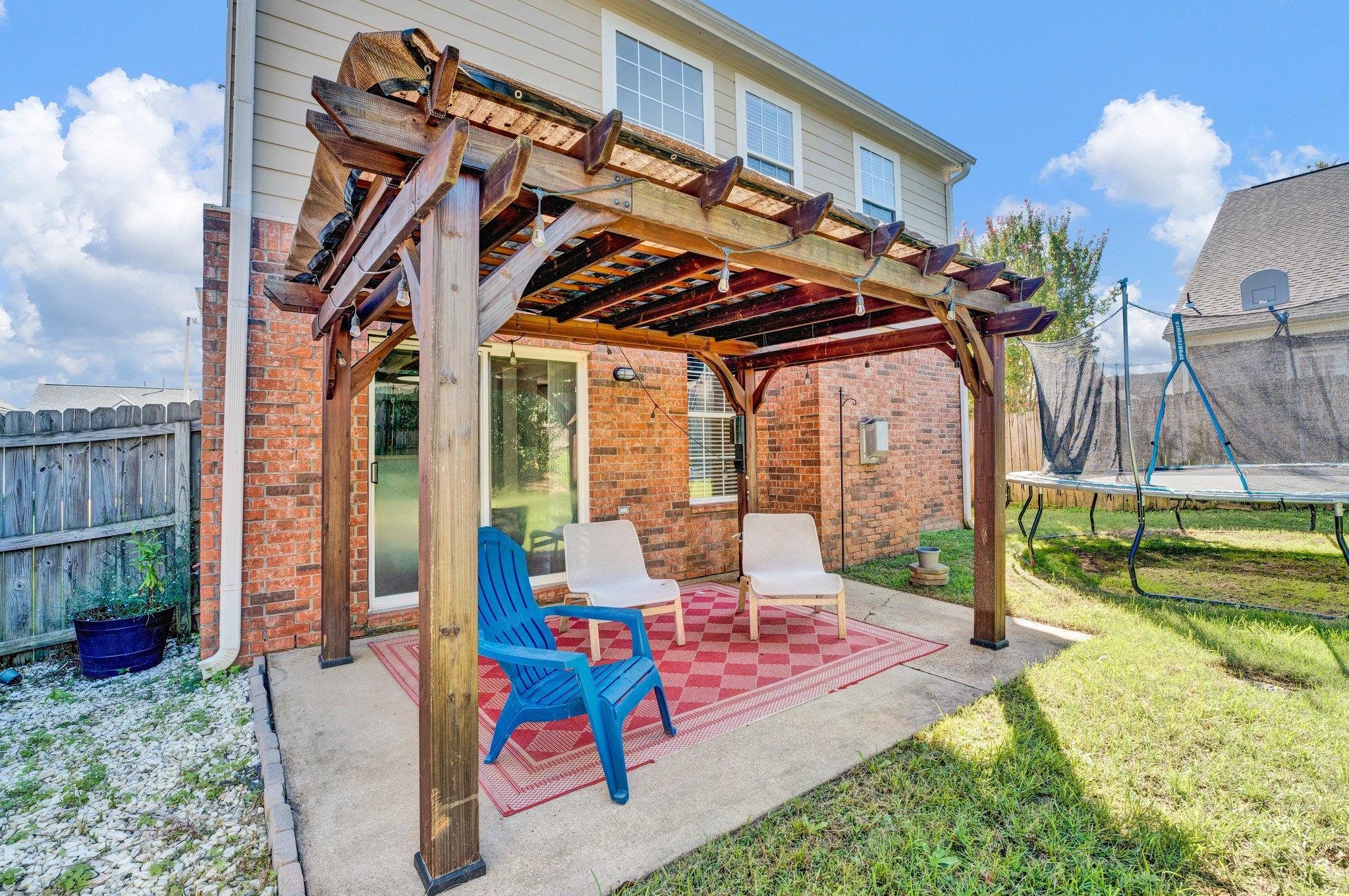 View of patio / terrace featuring a trampoline and a pergola