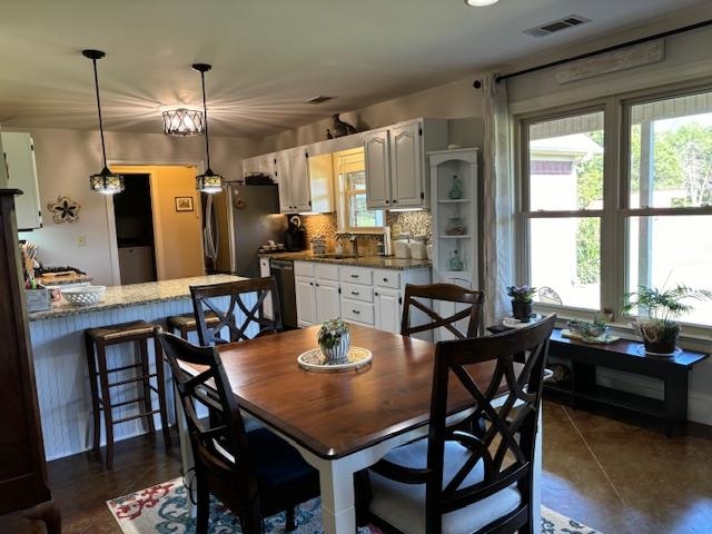 Tiled dining room with sink