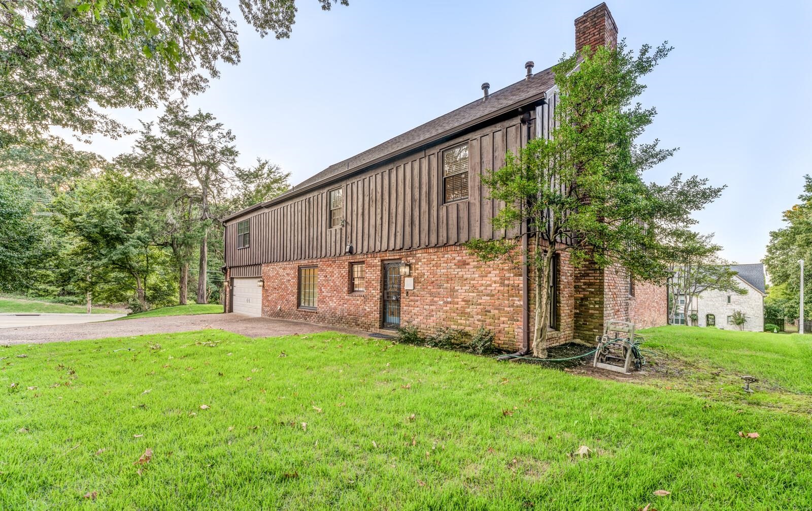 View of home\'s exterior with a yard and a garage