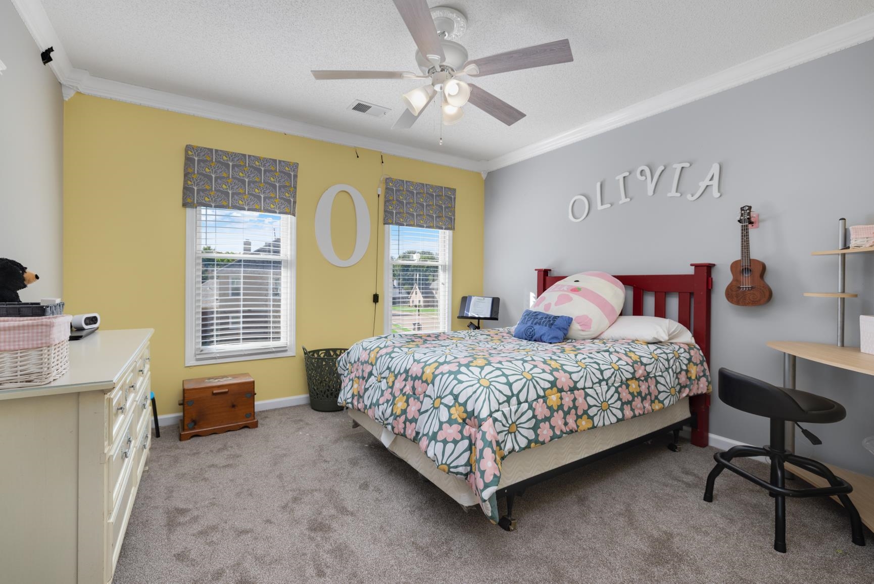 Bedroom with a textured ceiling, crown molding, light carpet, and ceiling fan