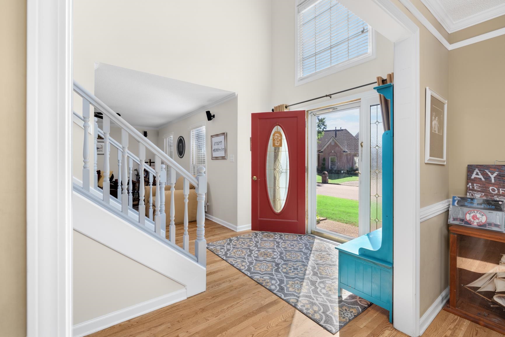 Entrance foyer featuring hardwood / wood-style floors and crown molding