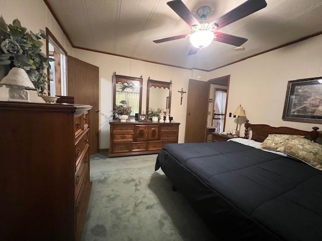 Bedroom featuring light carpet and ceiling fan