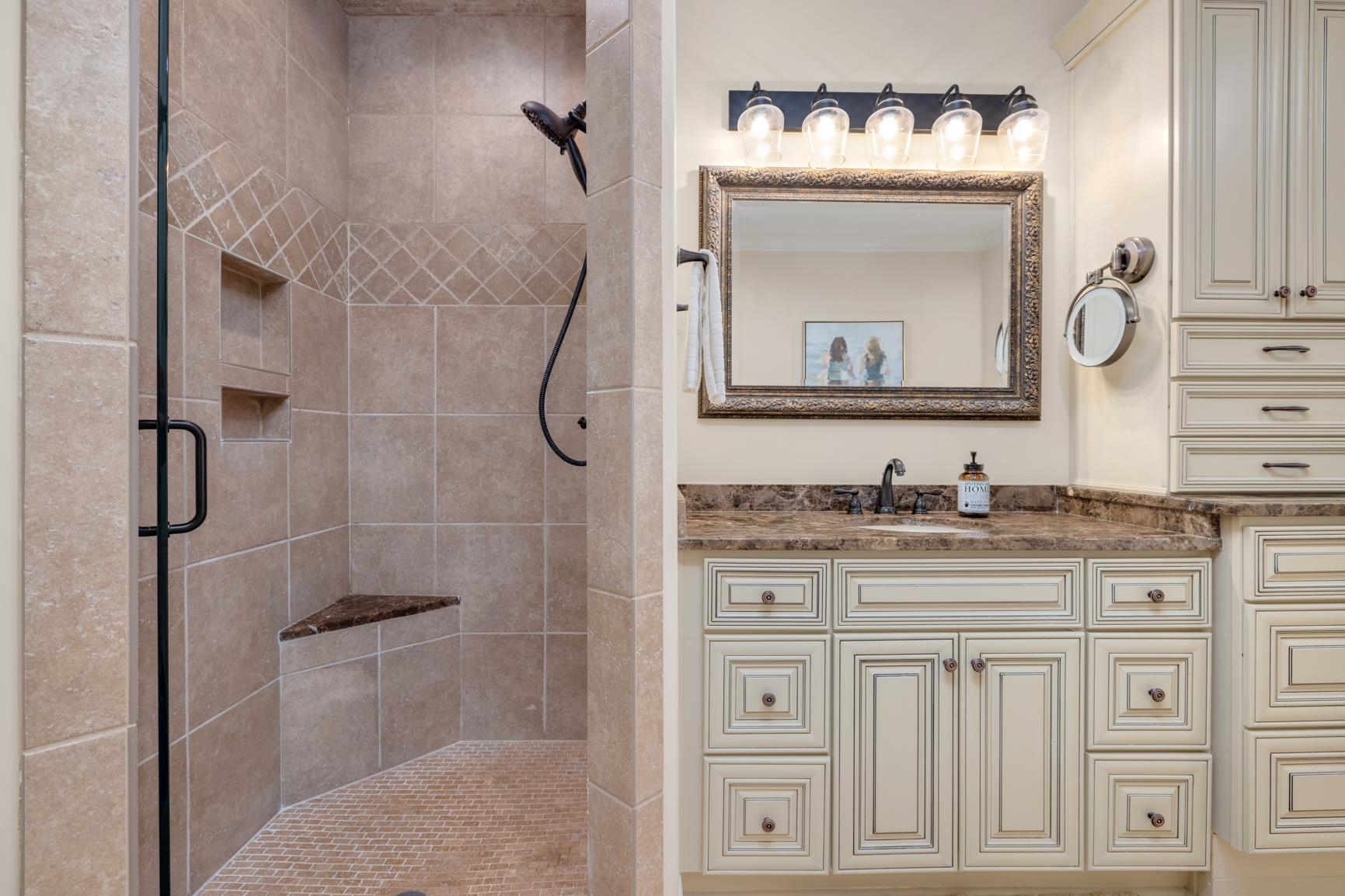 Bathroom featuring walk in shower and vanity