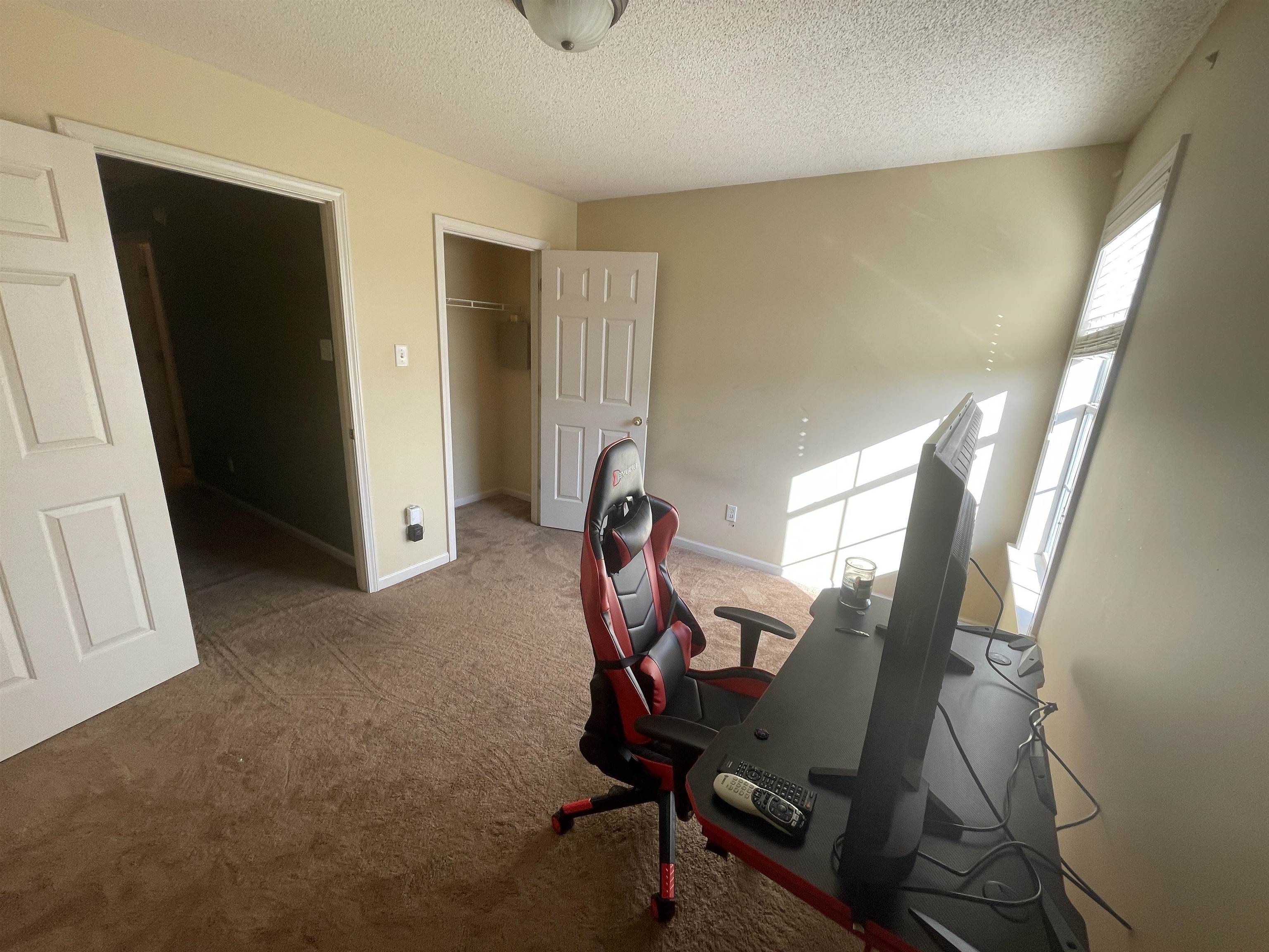 Workout room featuring carpet floors and a textured ceiling