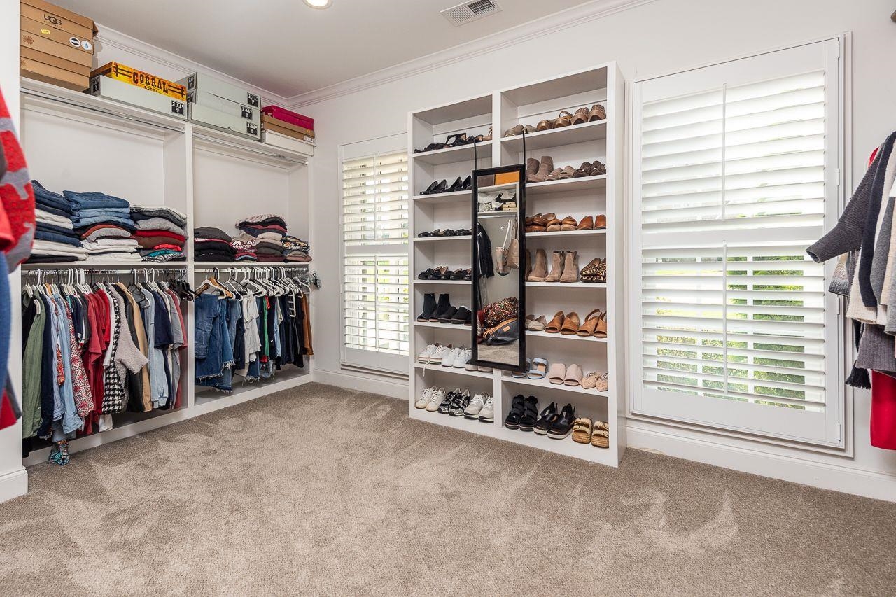 Spacious closet featuring light carpet