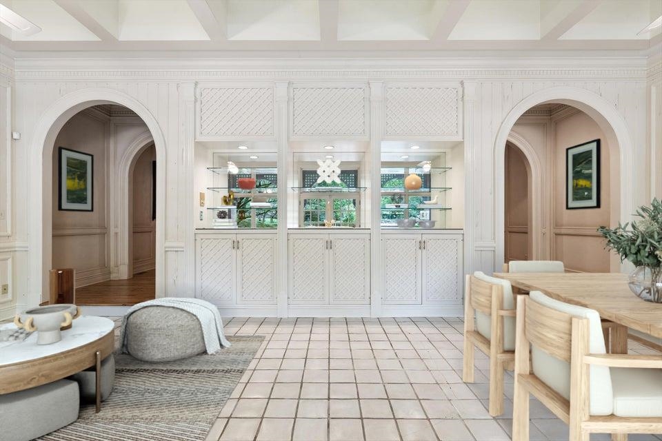 Arched openings from the Great Room lead to a large Sun Room with Wet Bar