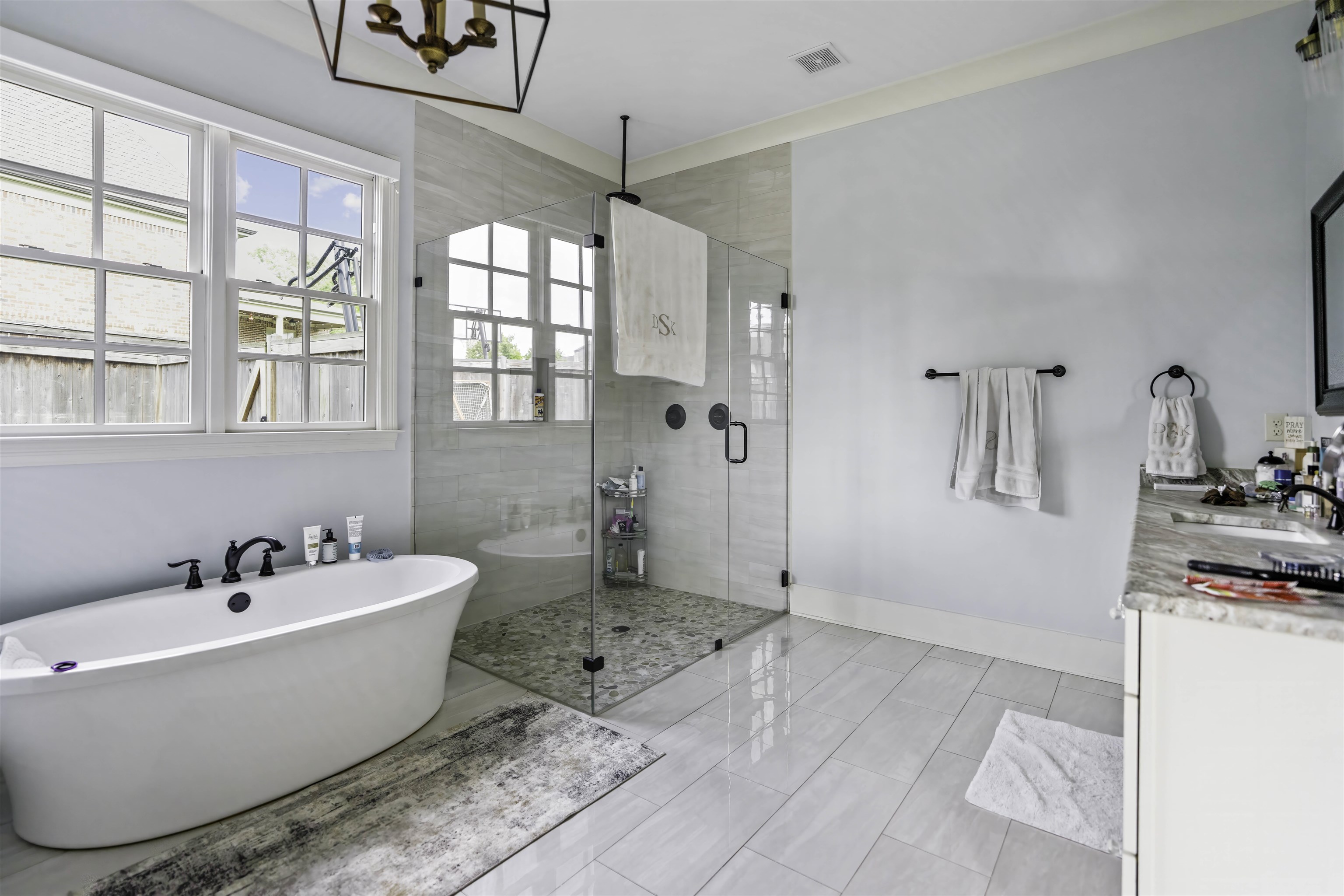 Bathroom featuring independent shower and bath, vanity, a chandelier, and tile patterned floors