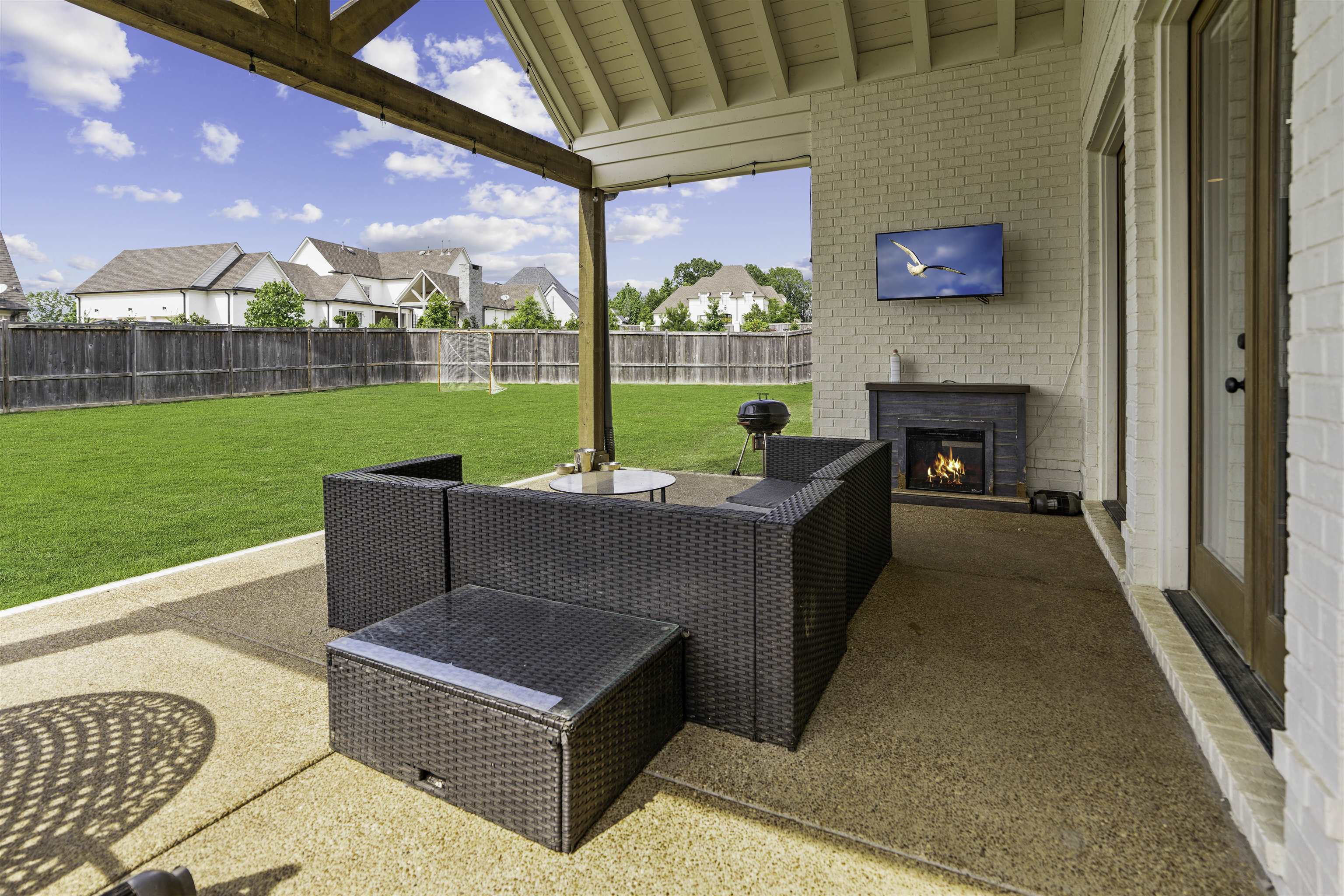 View of patio featuring exterior fireplace