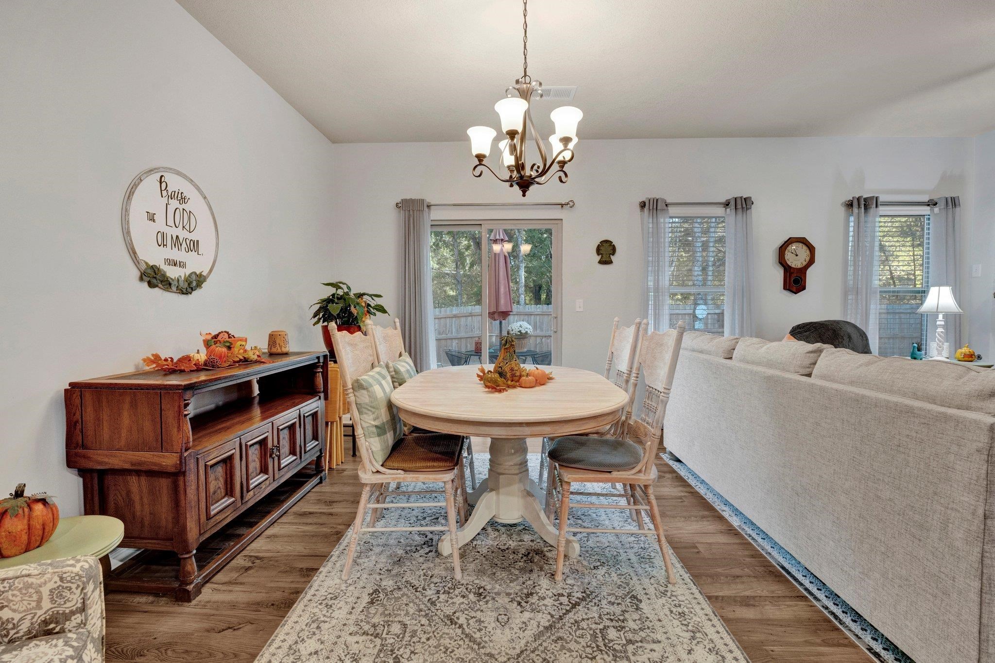 Dining space with a chandelier and dark hardwood / wood-style flooring