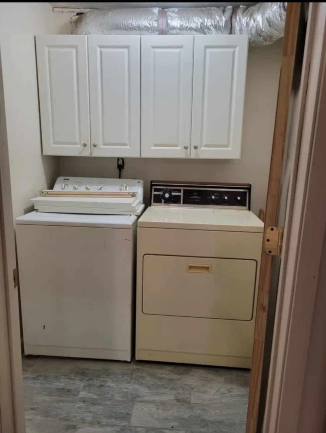 Laundry room featuring cabinets and washer and dryer