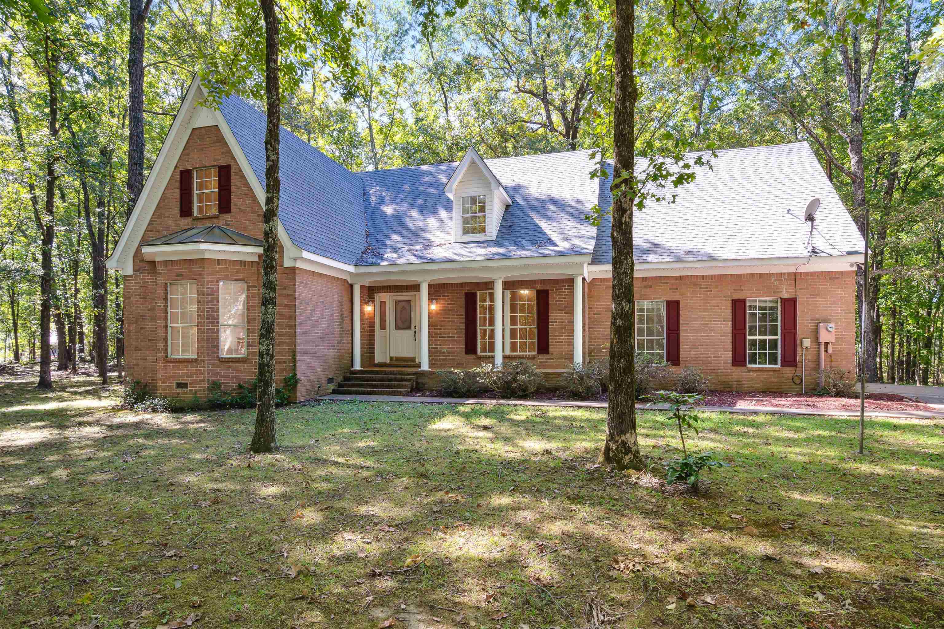 New england style home with a front lawn