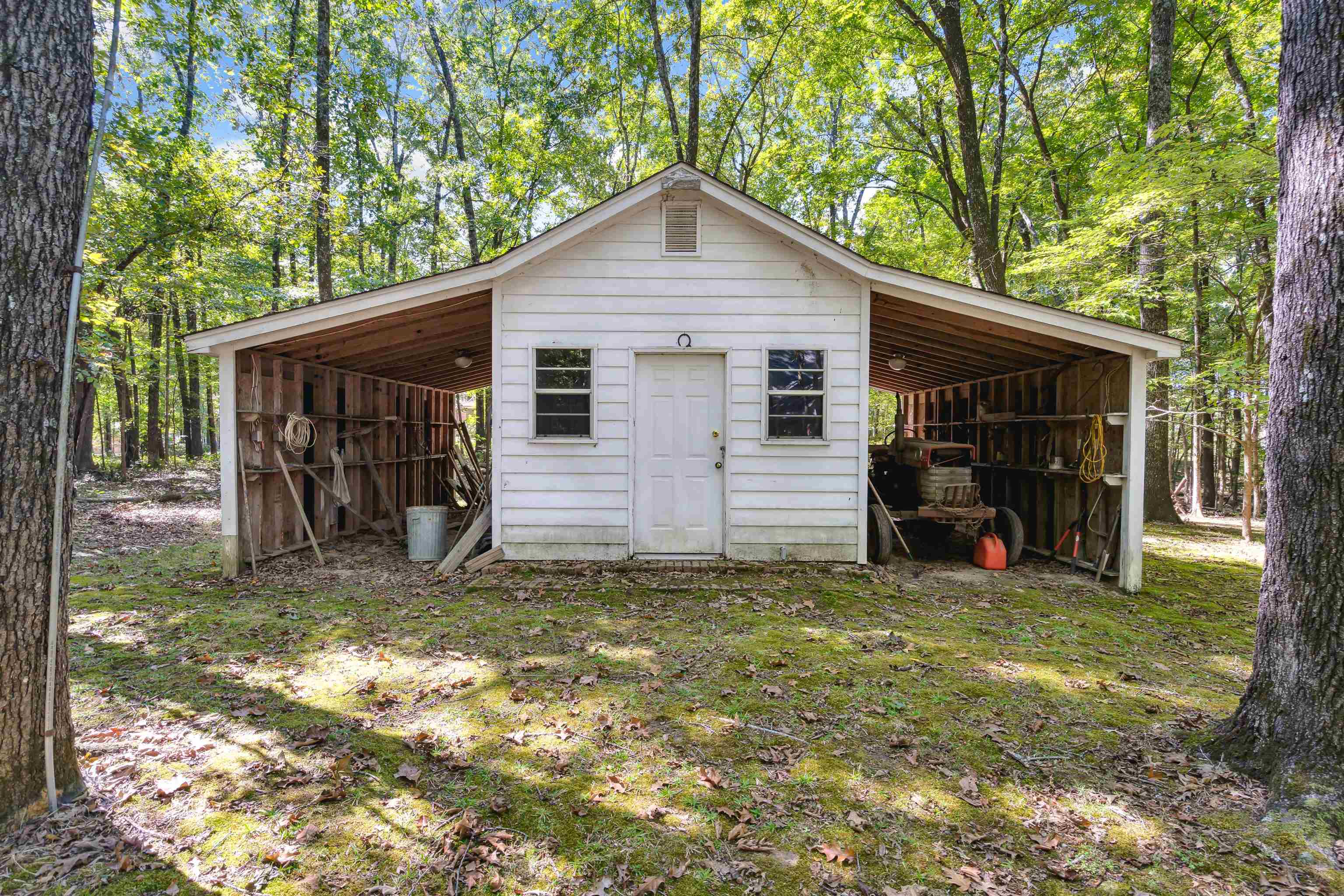 View of outbuilding with a lawn