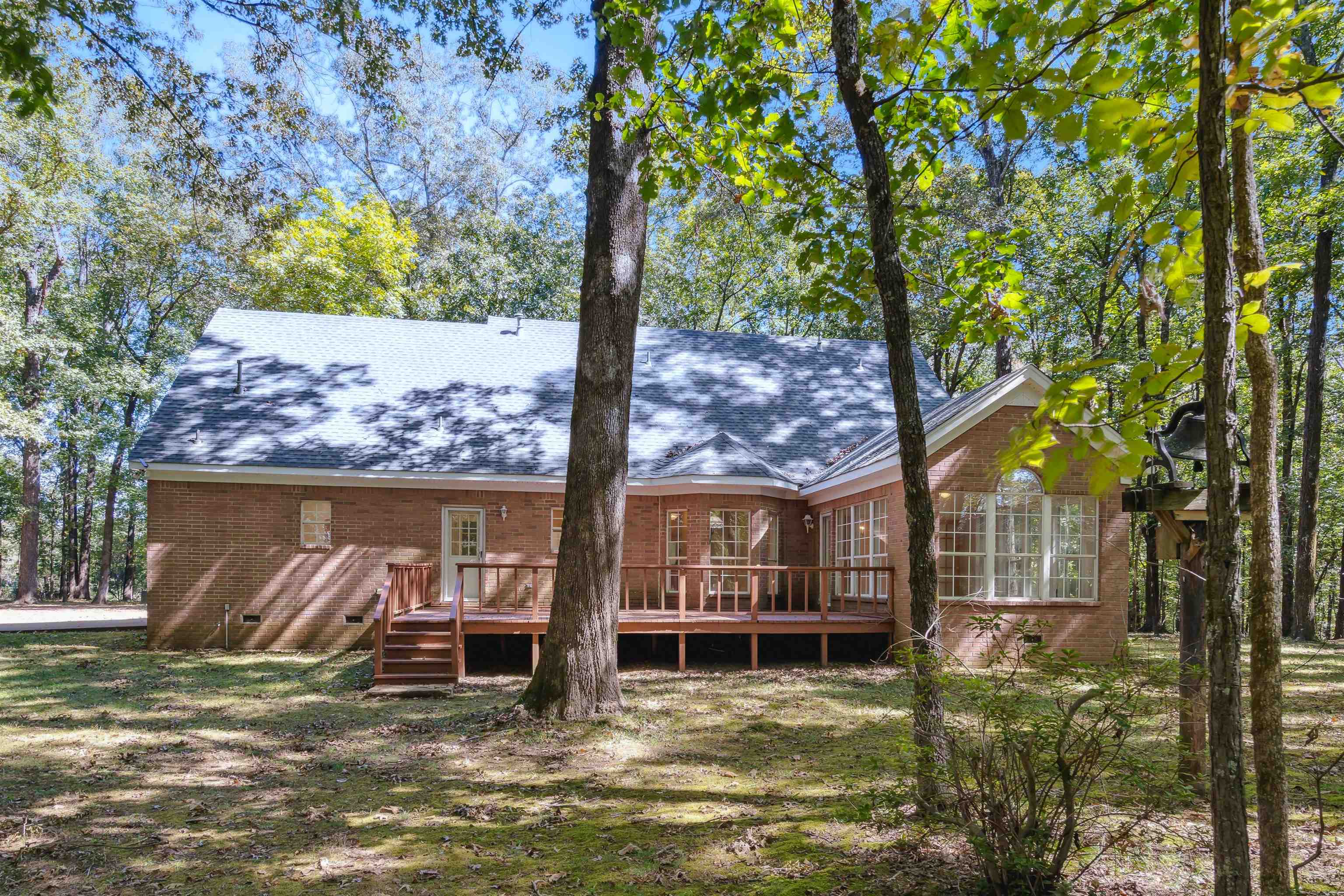 Rear view of property featuring a wooden deck