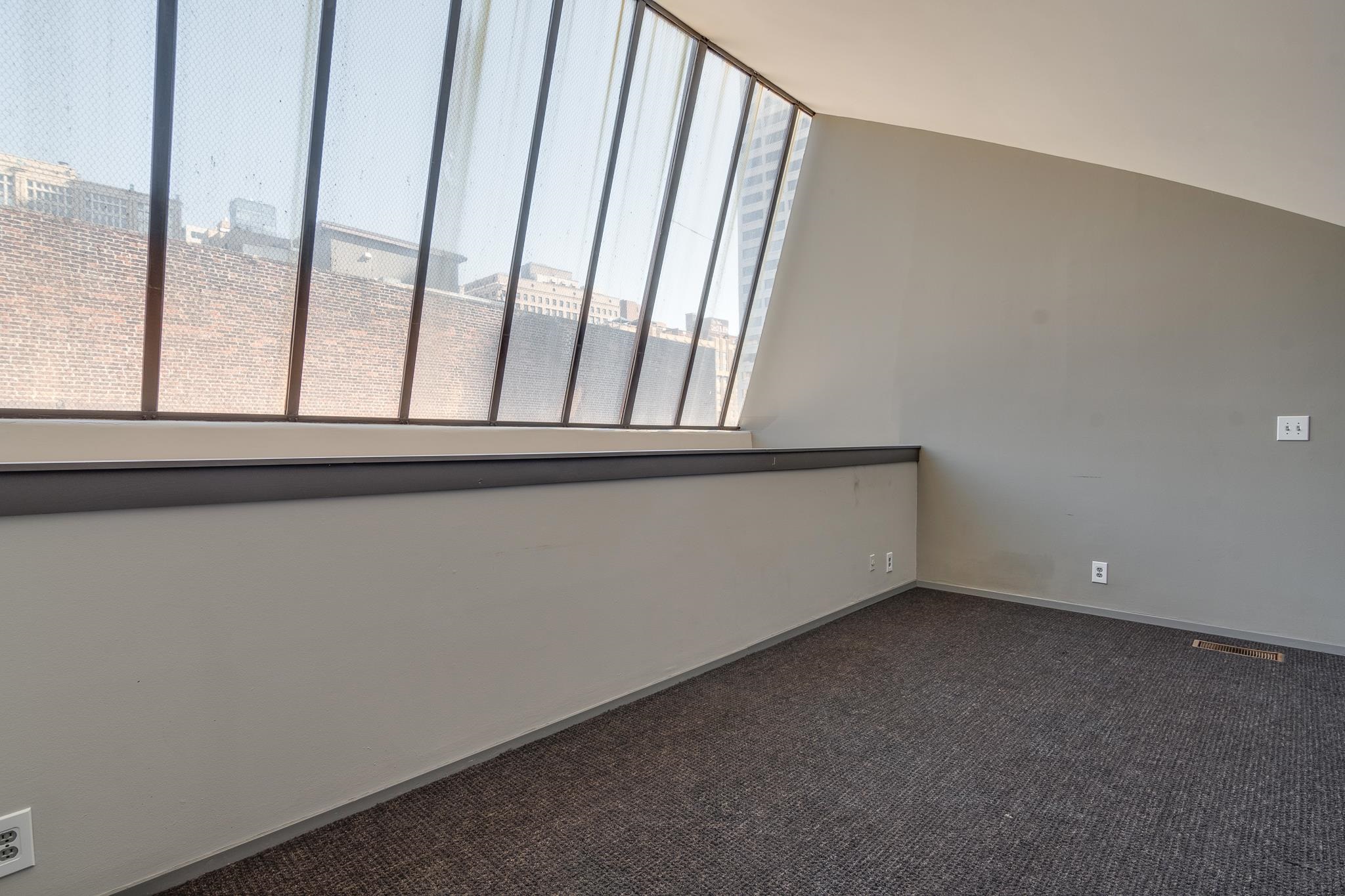 Unfurnished room with dark carpet