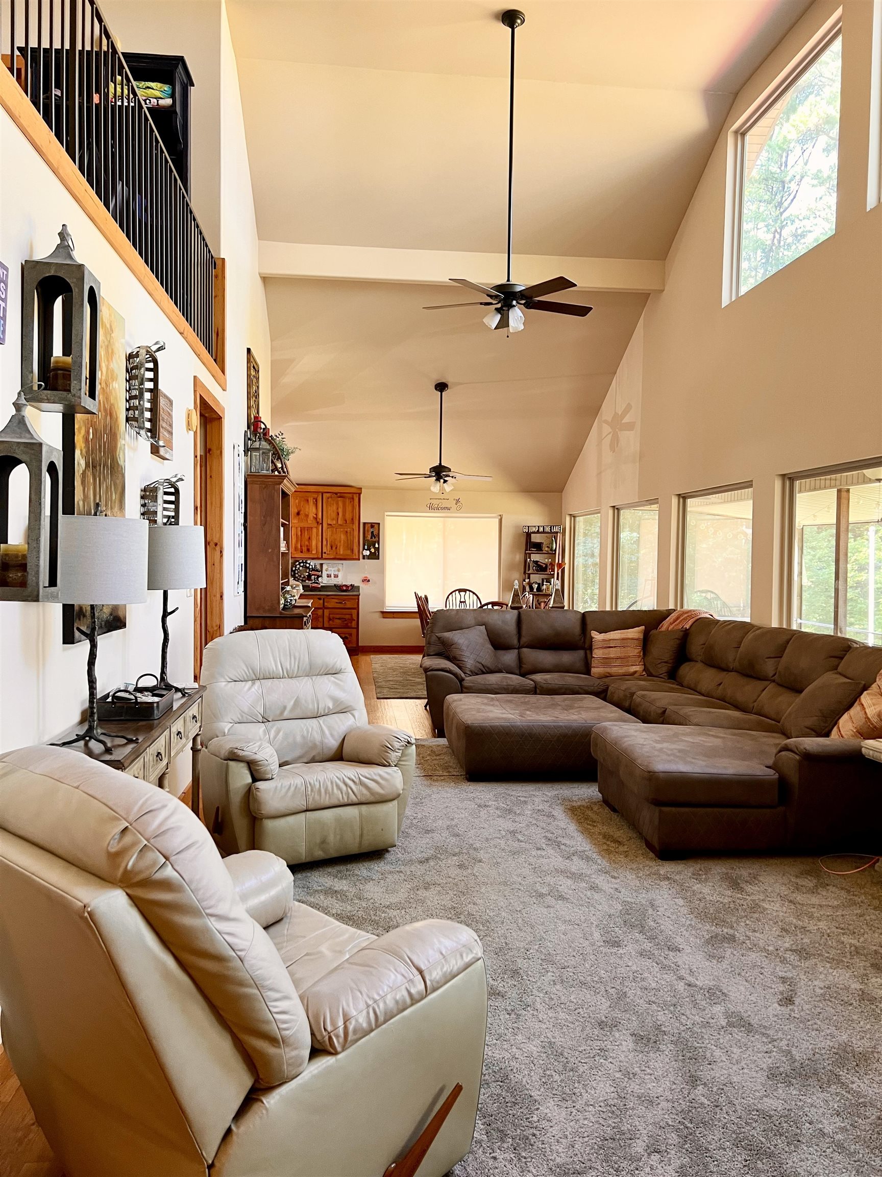 Living room with carpet and high vaulted ceiling