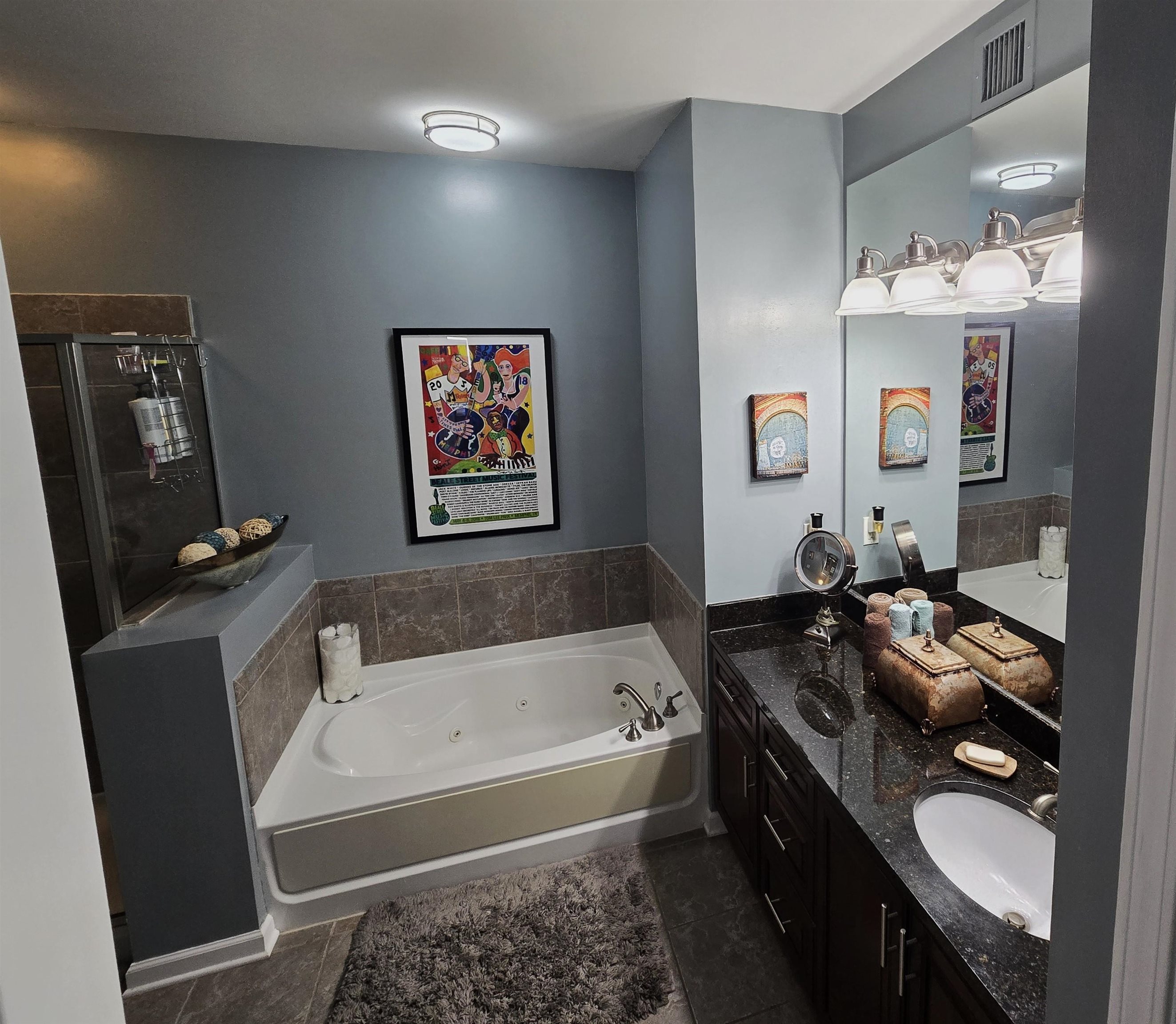 Bathroom with tile patterned floors, vanity, and independent shower and bath