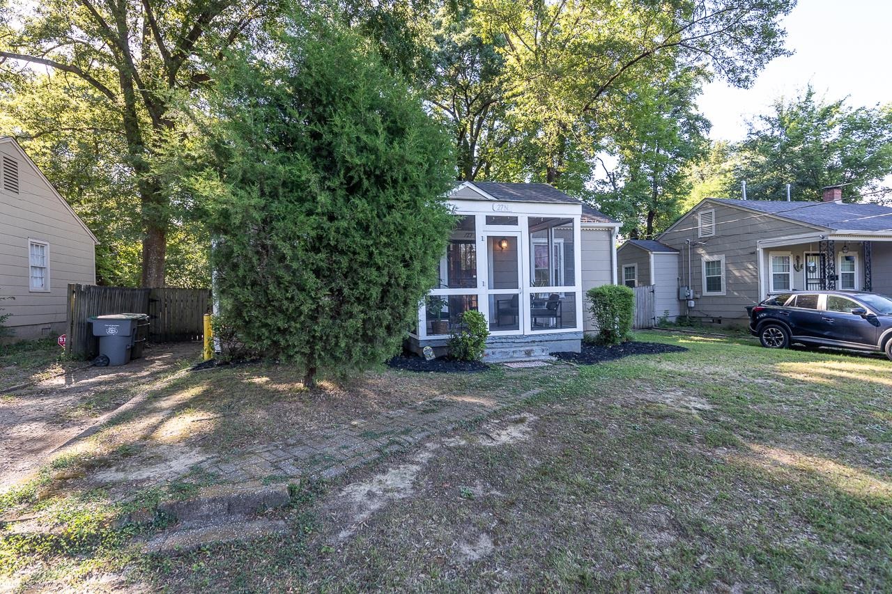 View of yard featuring a sunroom